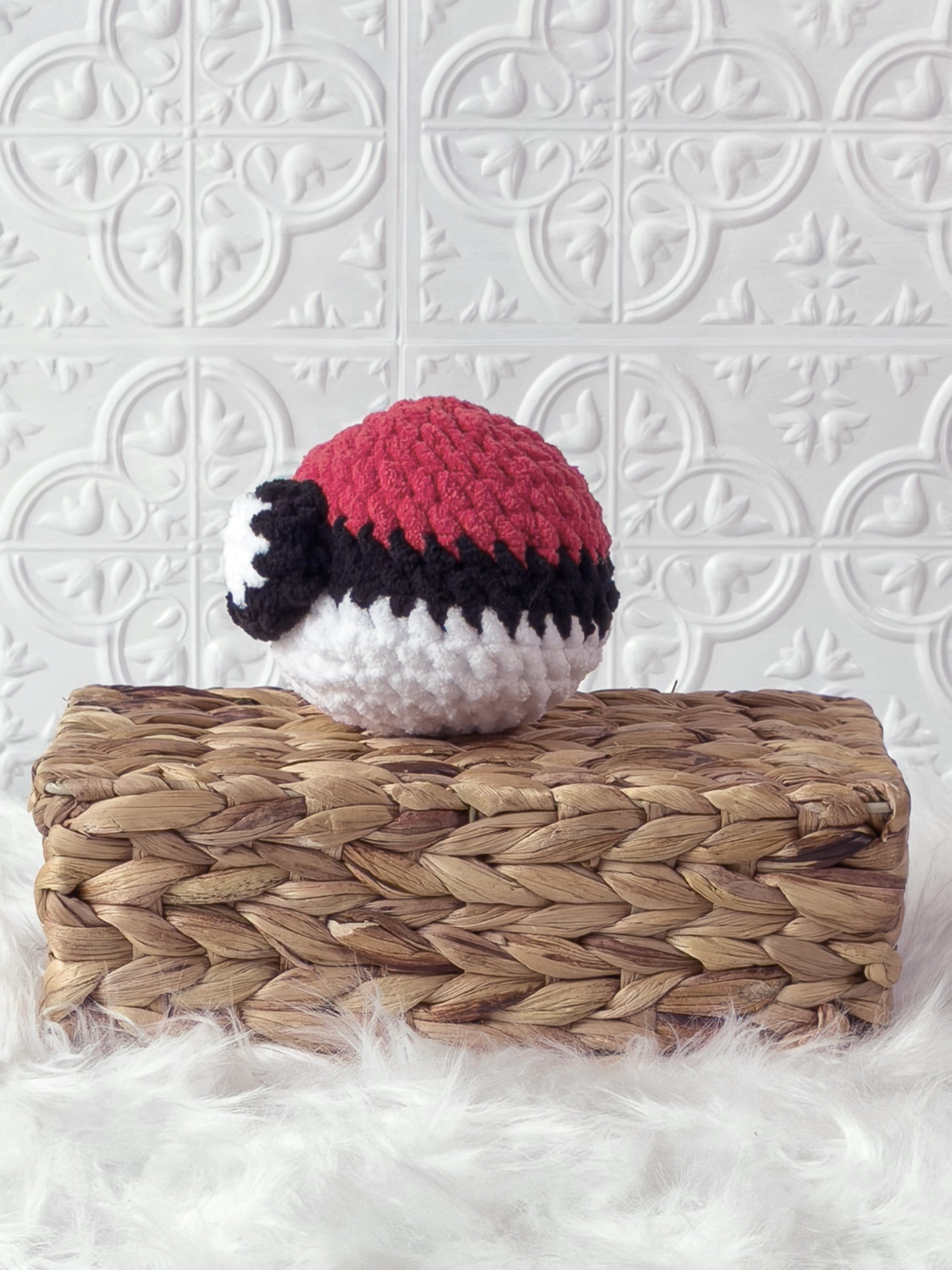 Handmade Poké Ball crochet plushie with a round colour-blocked design