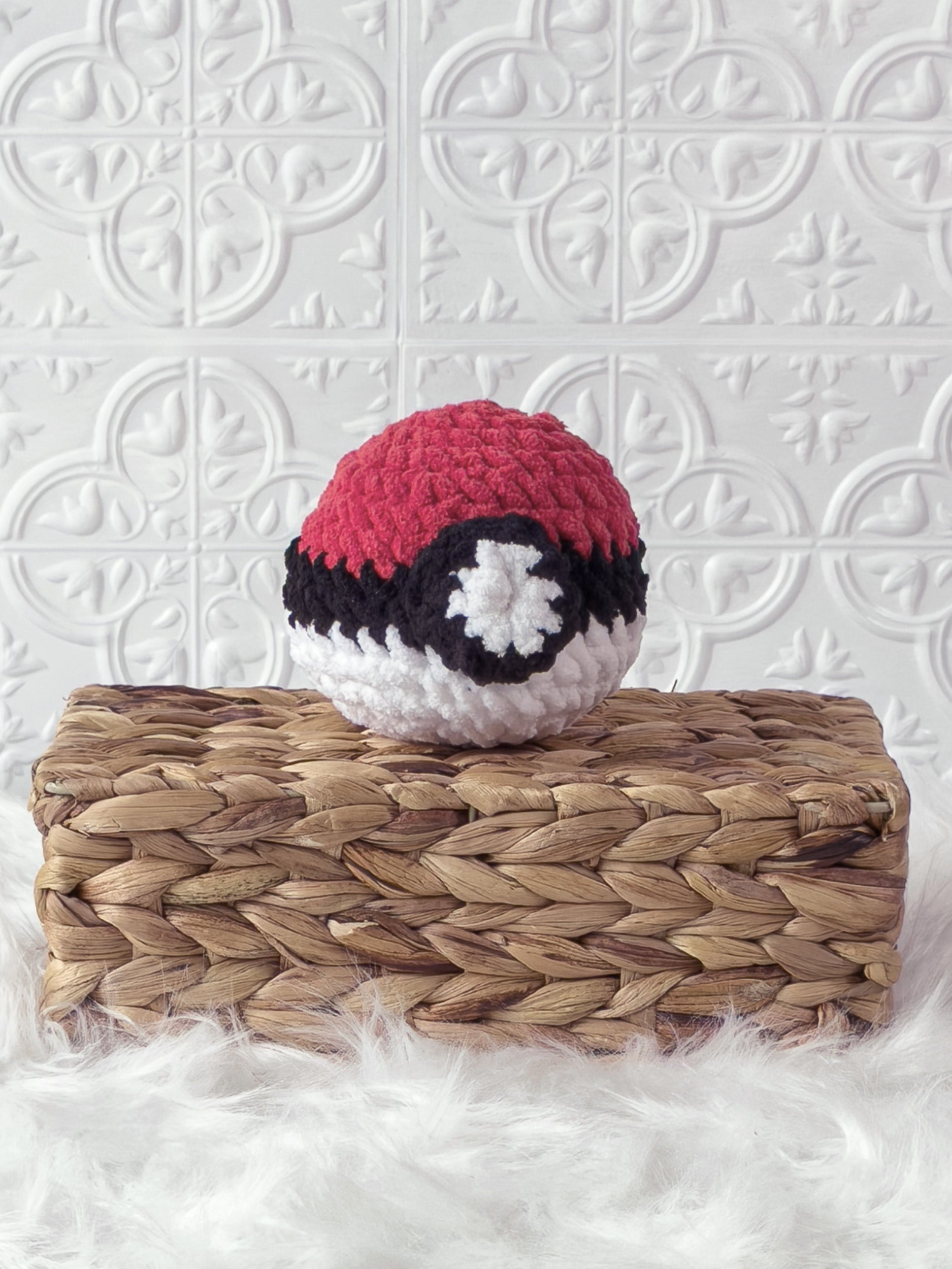 Handmade red poke ball crochet plushie shown from the front