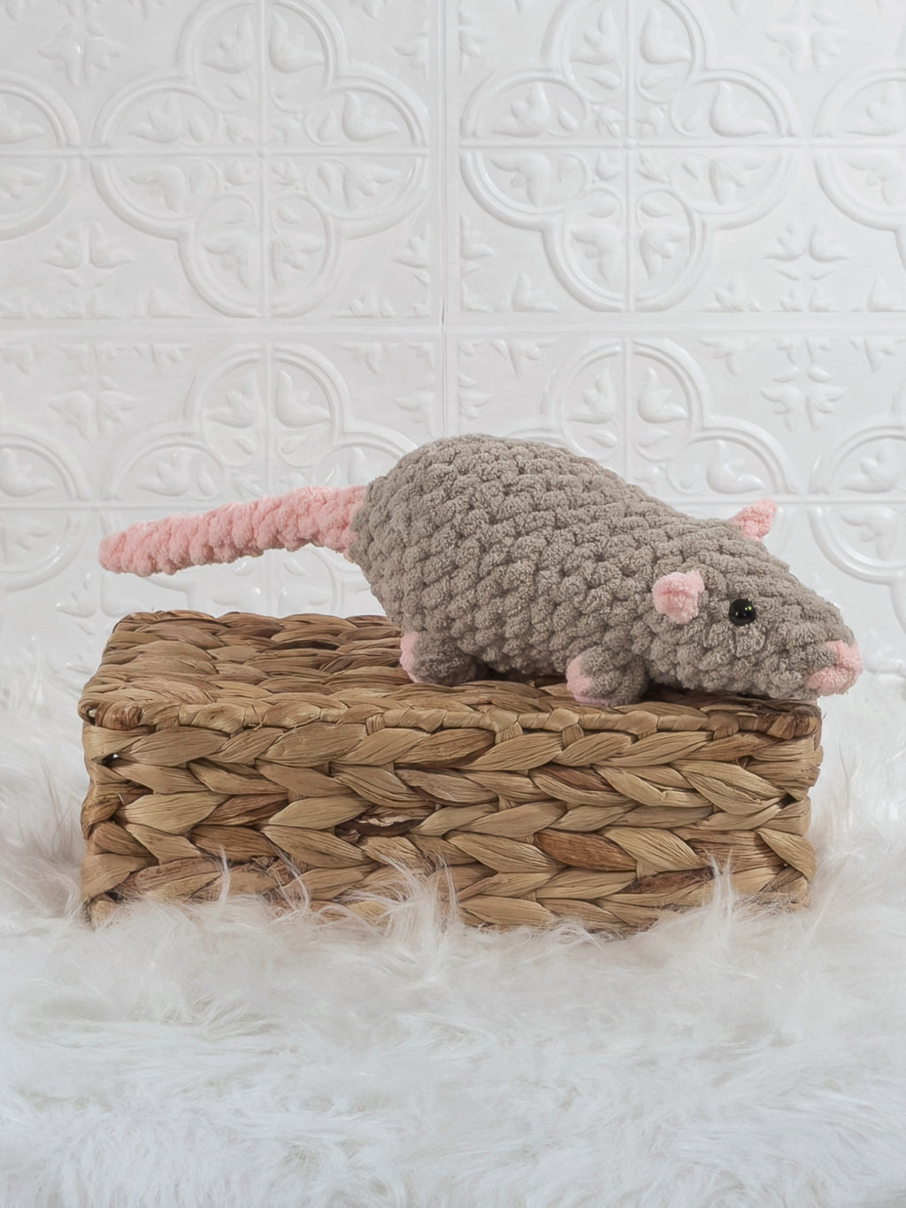 Handmade taupe rat crochet plushie shown from an angled view