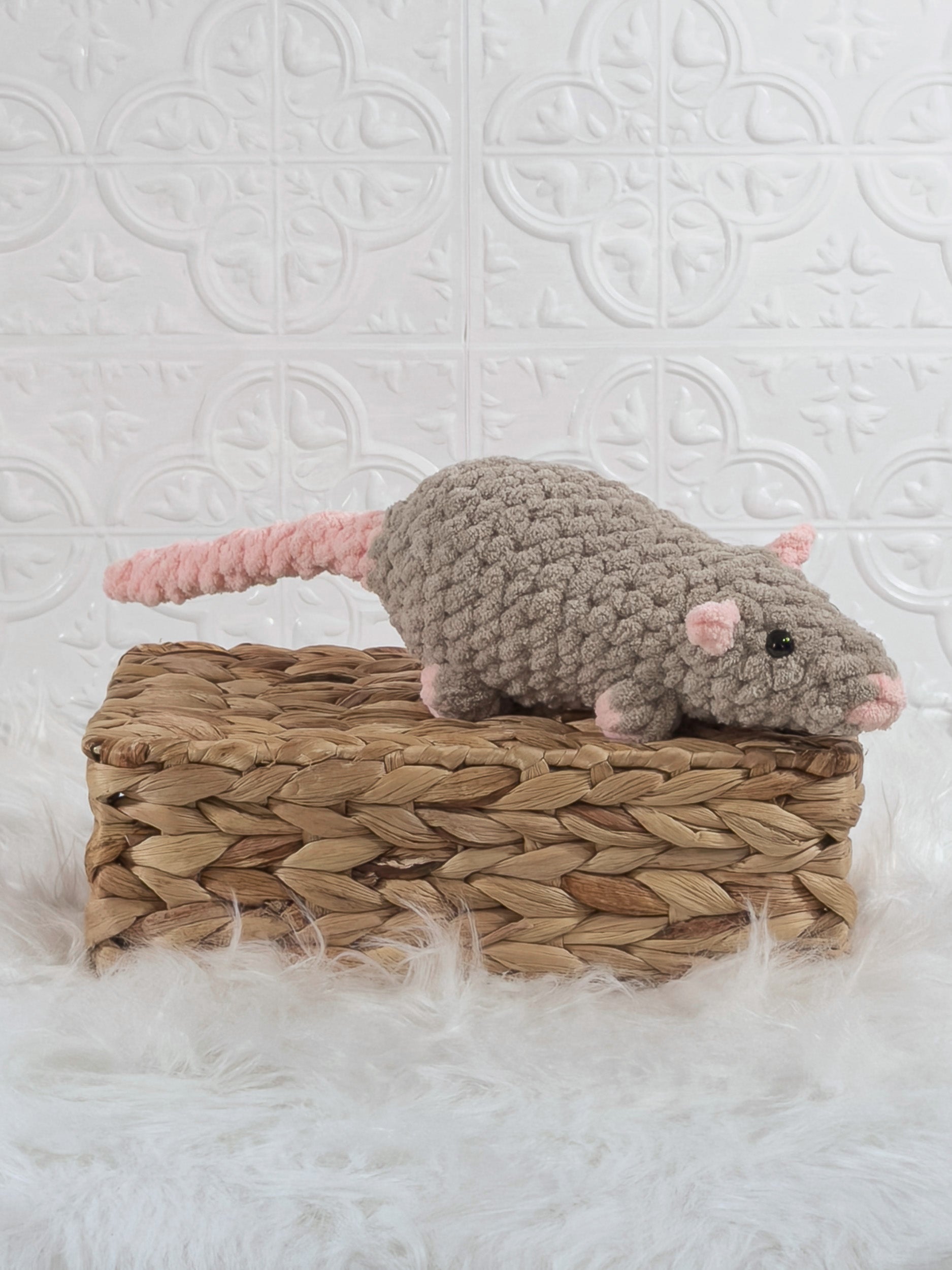 Handmade taupe rat crochet plushie shown from an angled view
