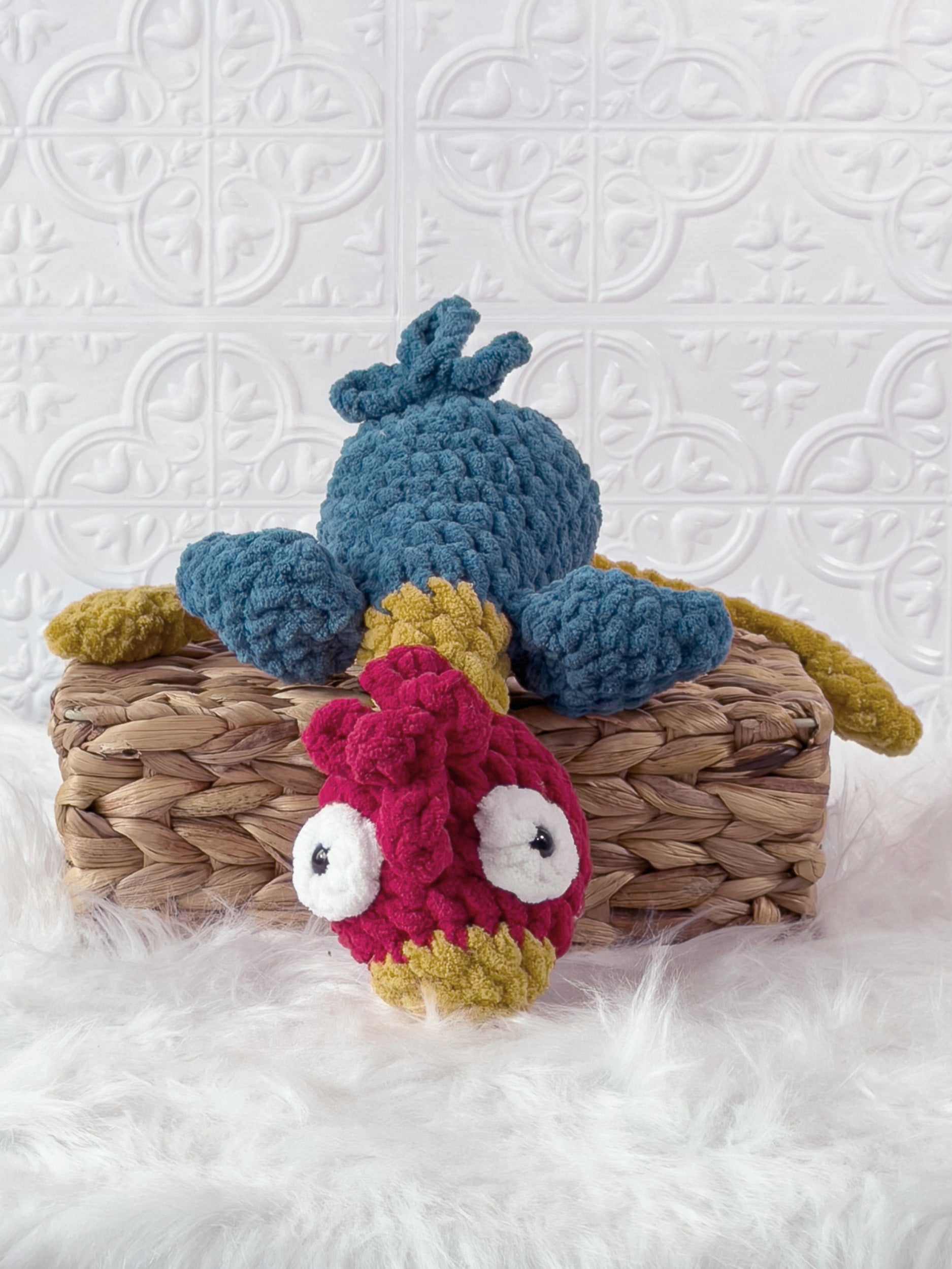 Handmade turquoise silly rooster crochet plushie shown from an angled view