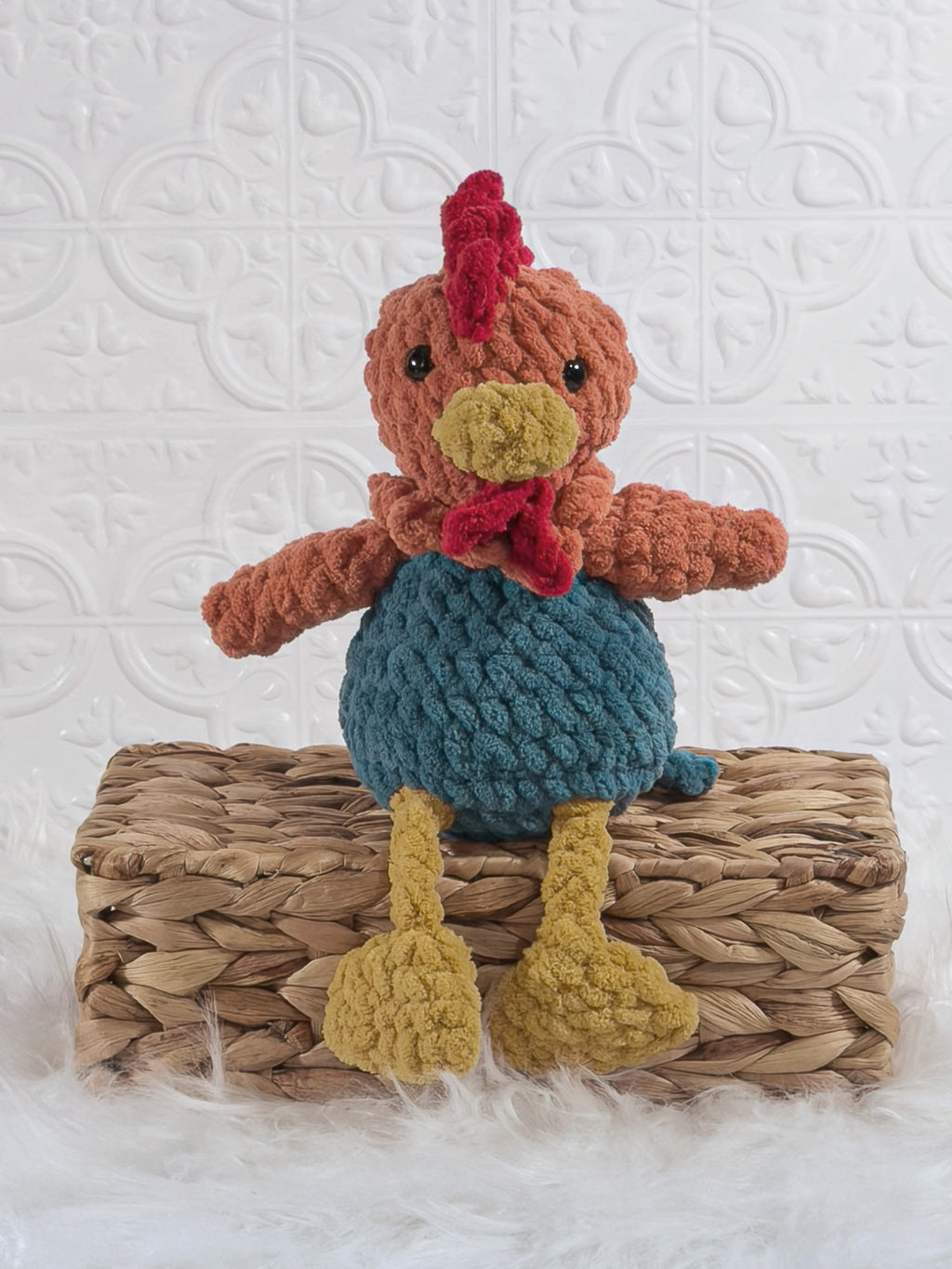 Handmade turquoise sitting rooster crochet plushie shown from the front