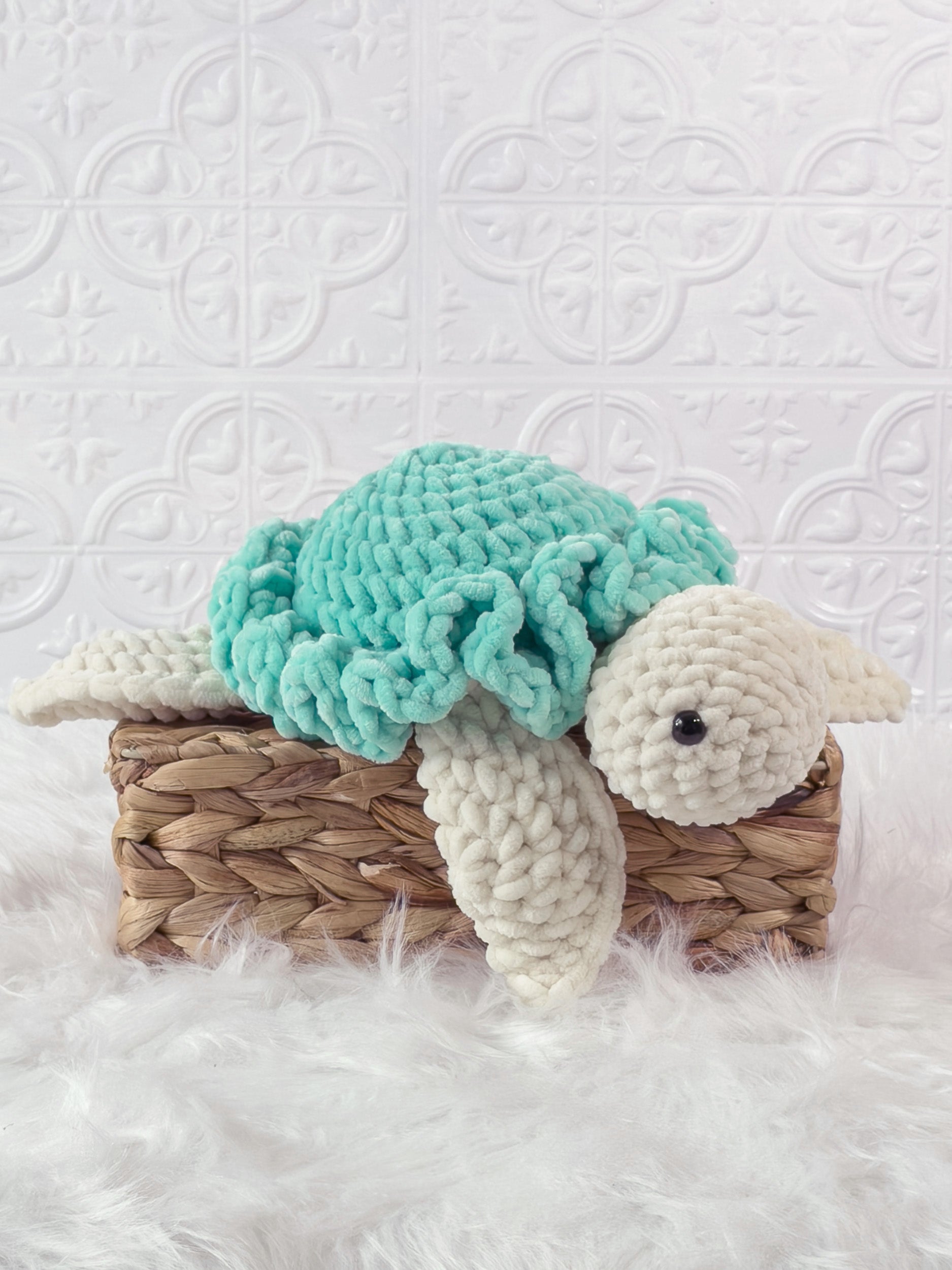 Handmade turquoise turtle crochet plushie shown from an angled view