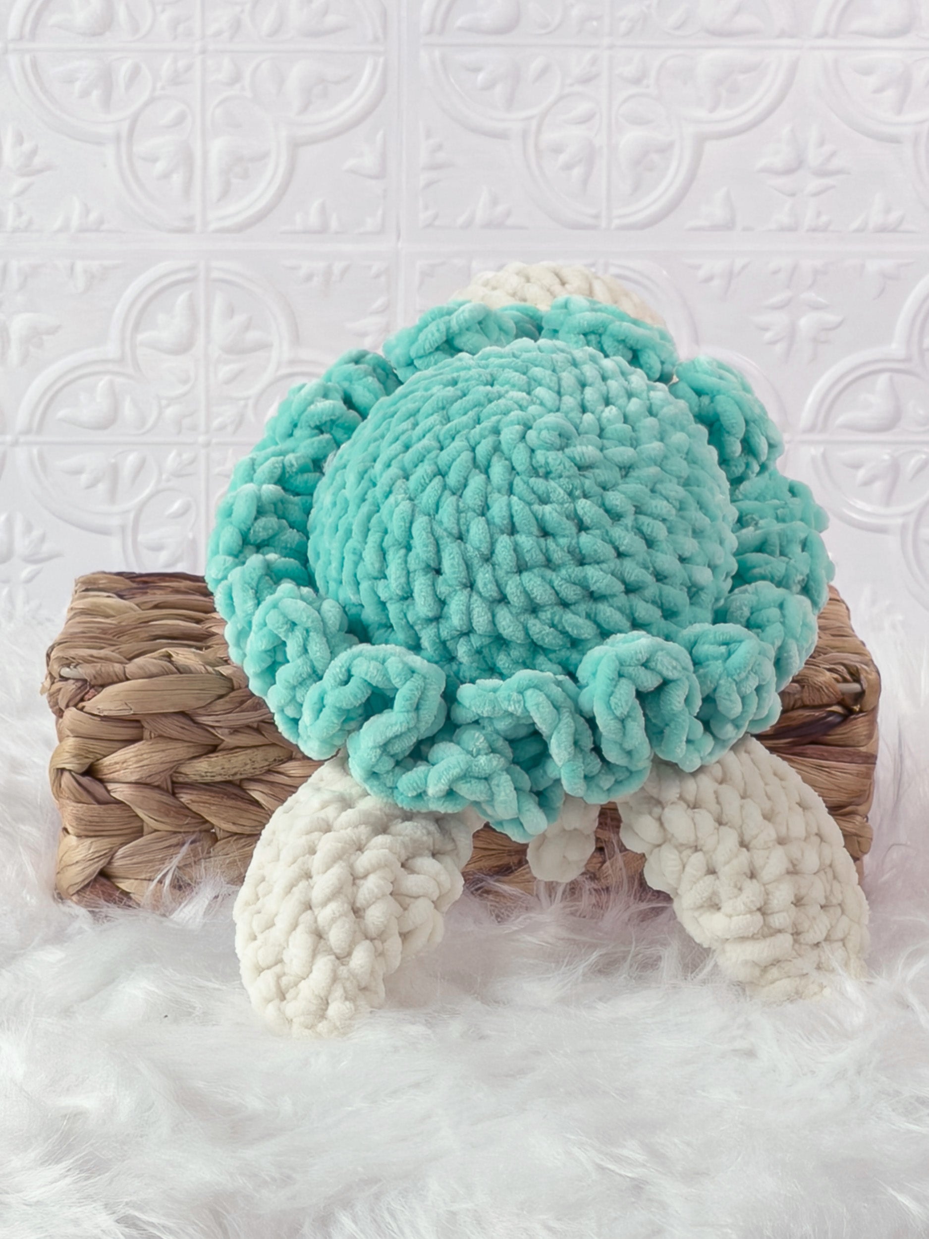 Handmade turquoise turtle crochet plushie shown from the back