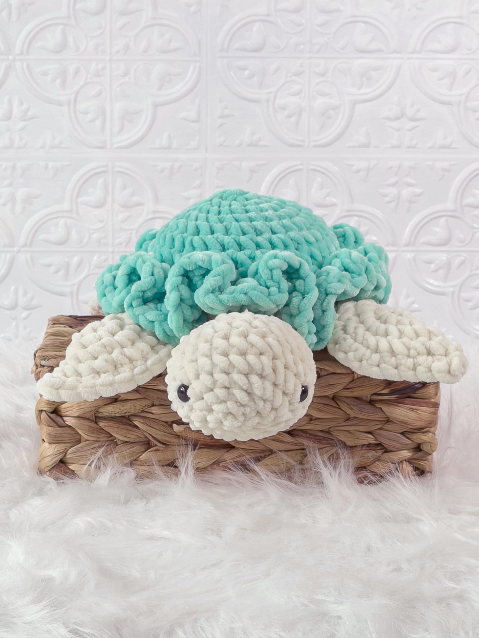 Handmade turquoise turtle crochet plushie shown from the front