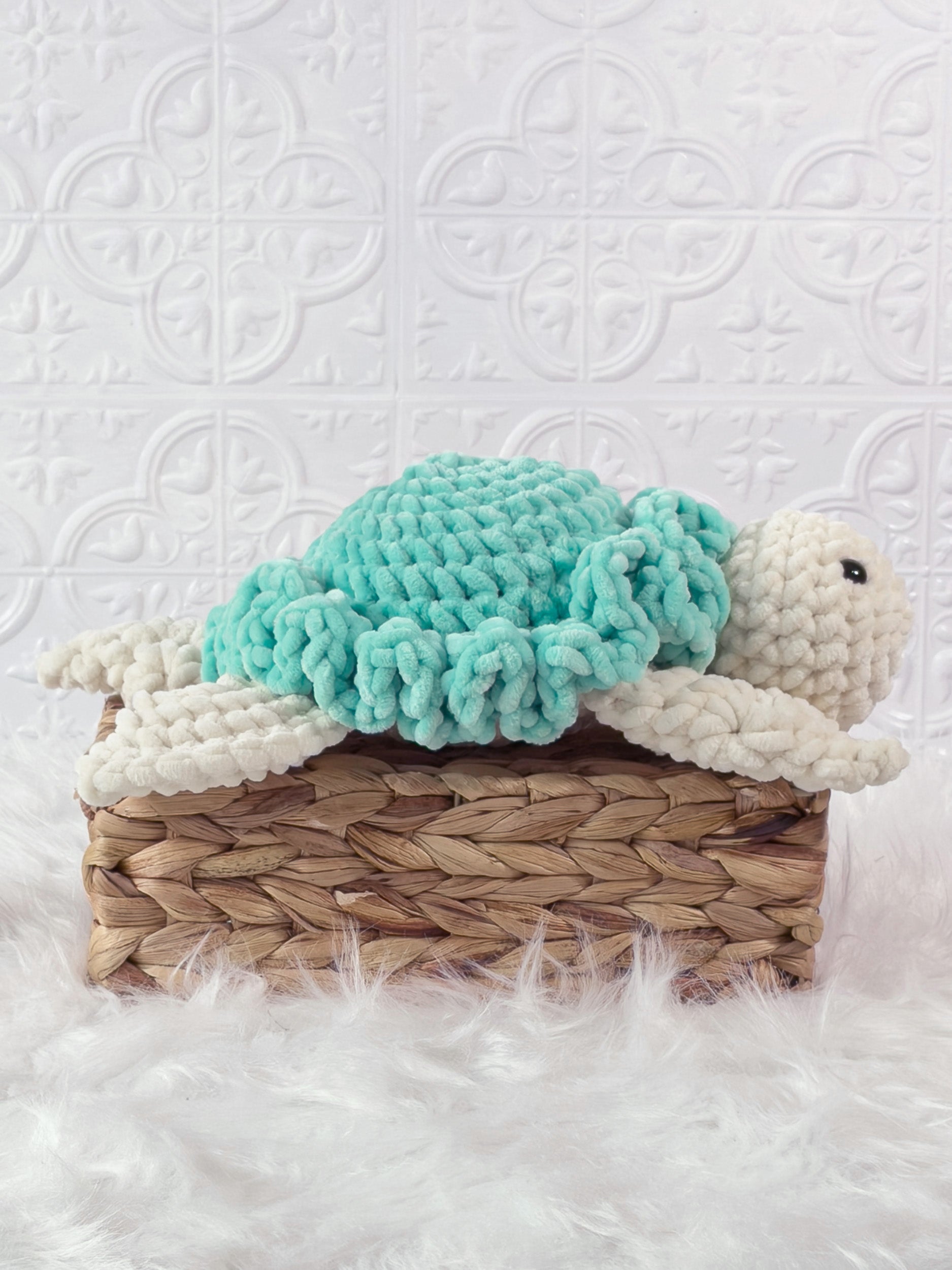 Handmade turquoise turtle crochet plushie shown from the side