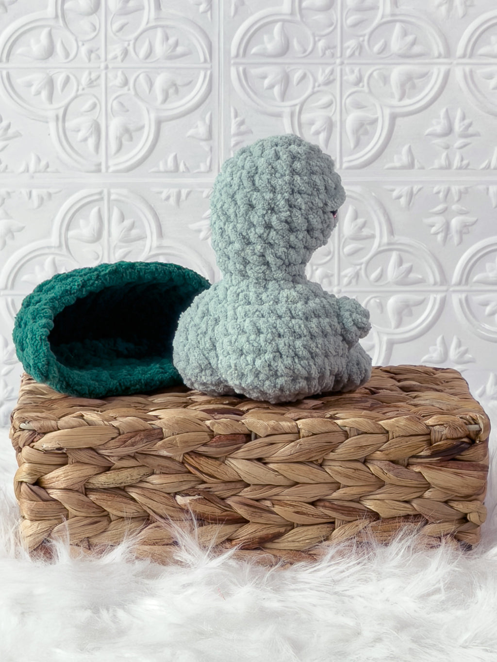 Handmade turquoise, dark turtle crochet plushie showing its playful cheeky expression