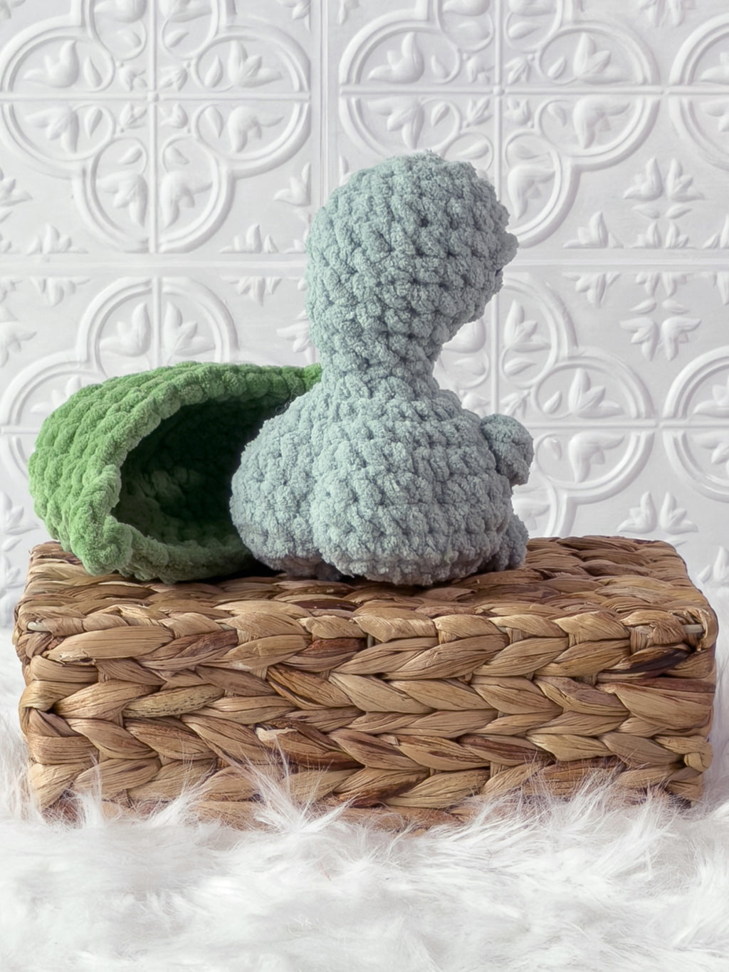Handmade turquoise, light turtle crochet plushie showing its playful cheeky expression