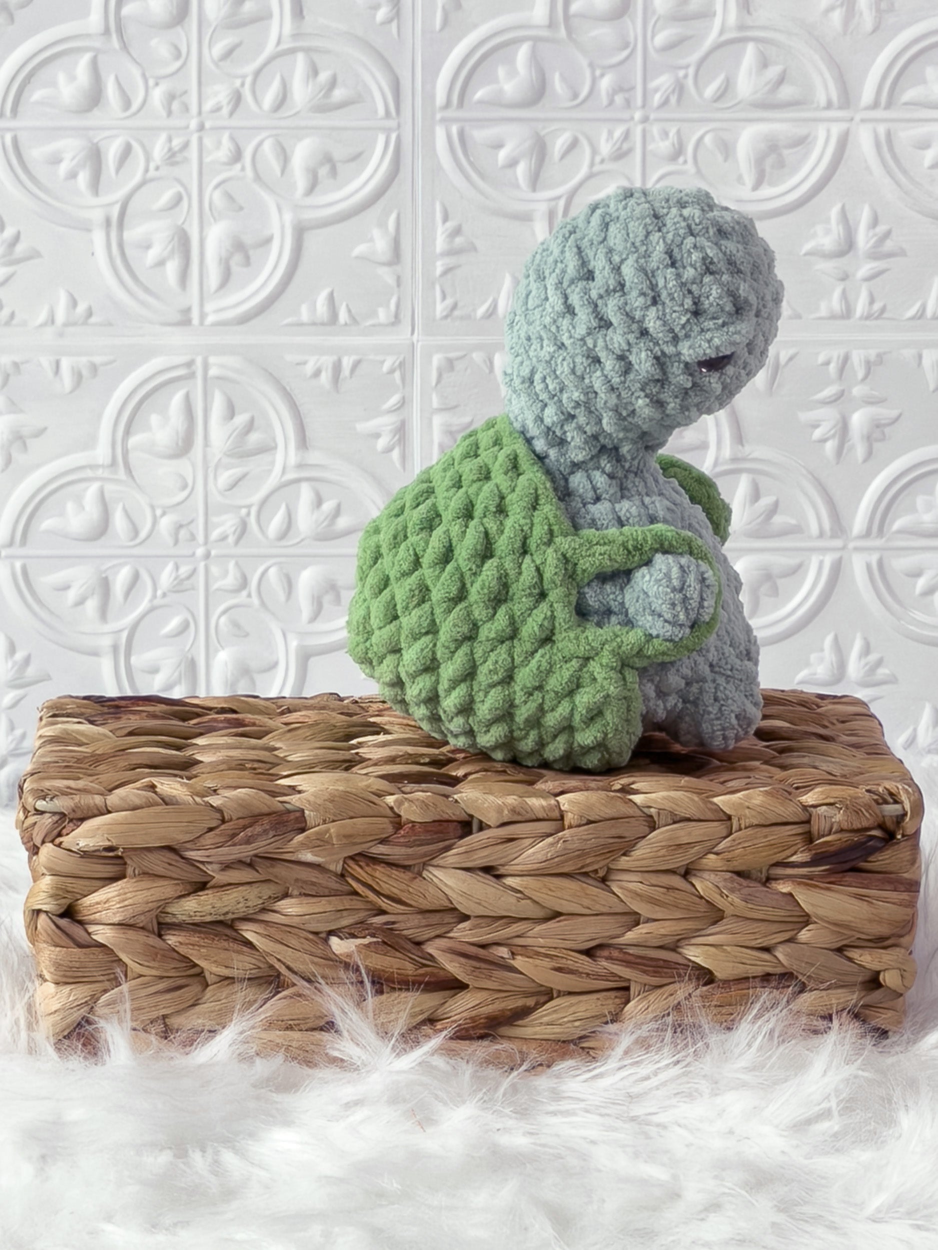 Handmade turquoise, light turtle crochet plushie shown from the back