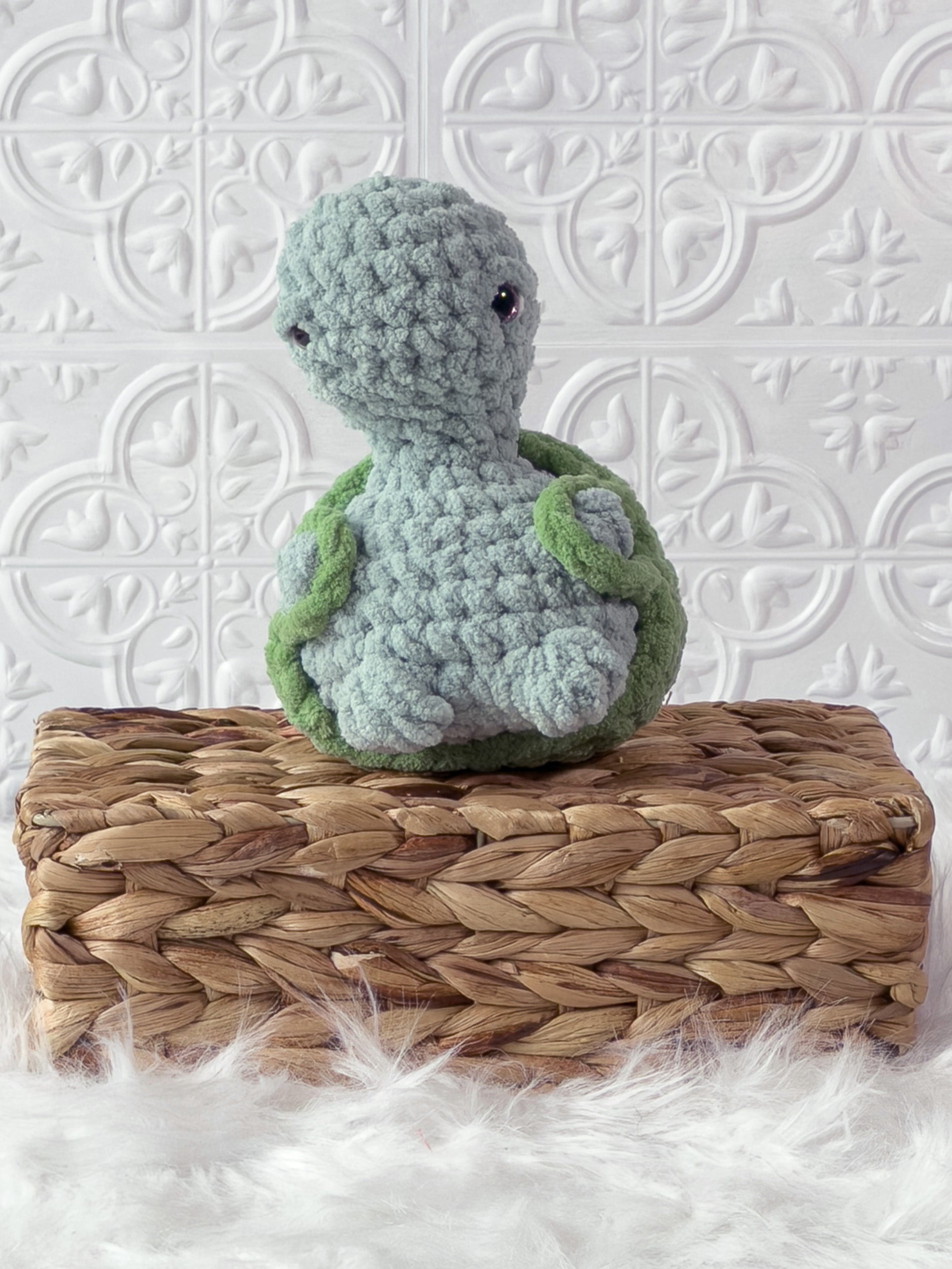 Handmade turquoise, light turtle crochet plushie shown from the front