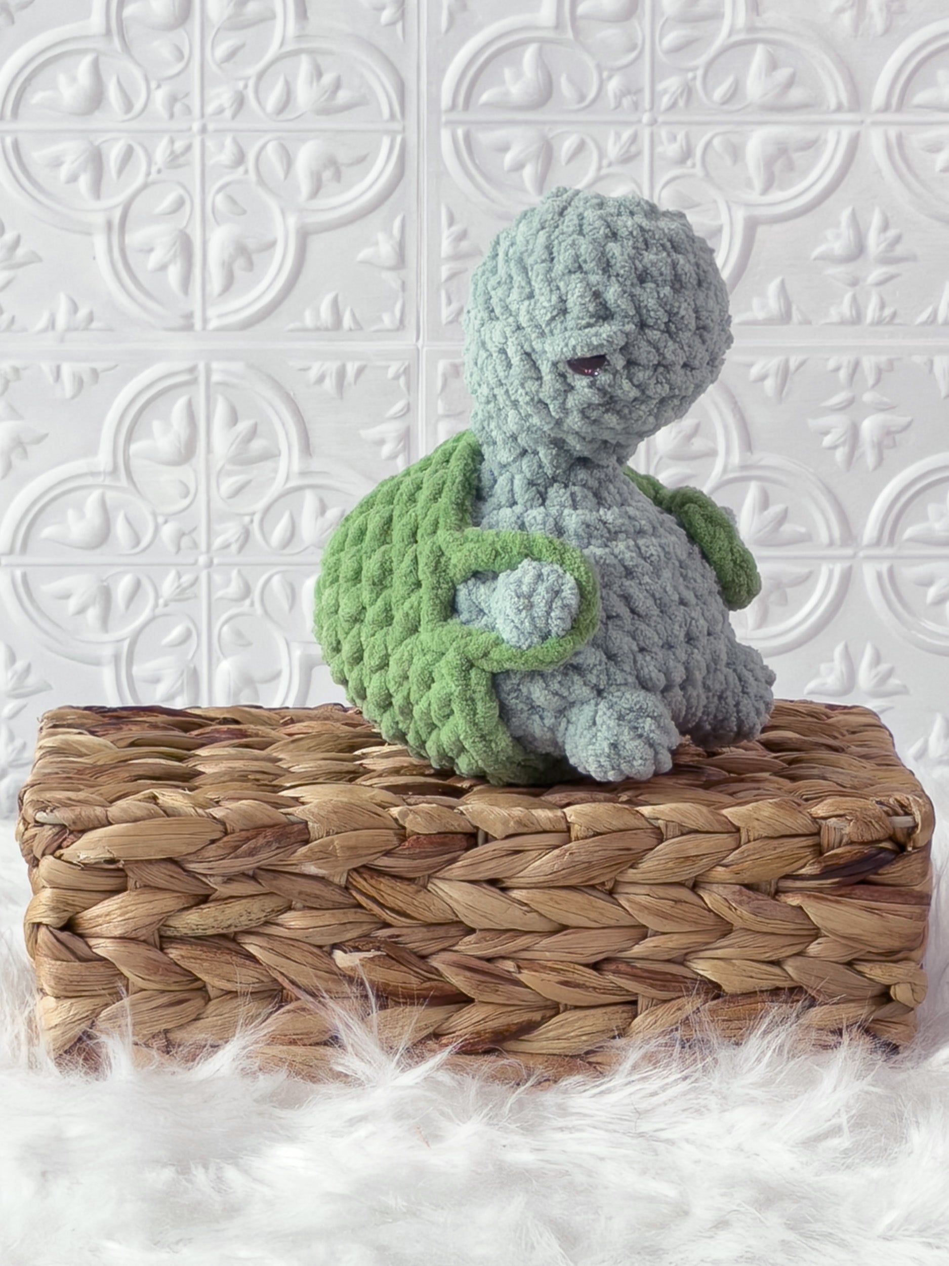 Handmade turquoise, light turtle crochet plushie shown from the side