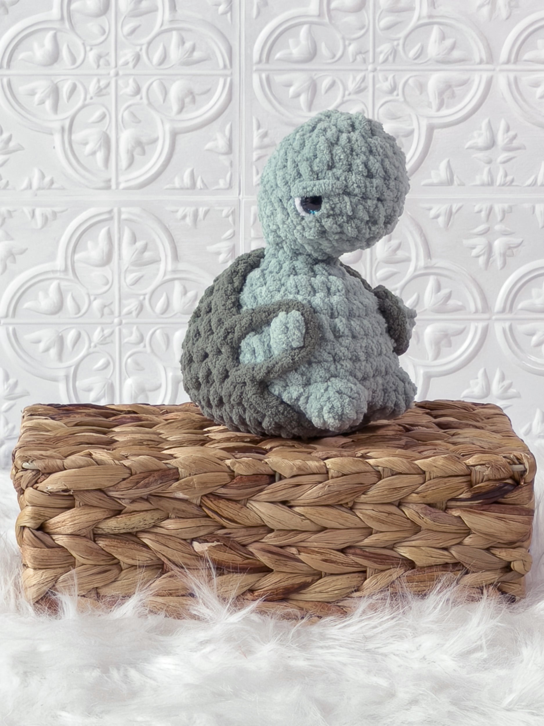 Handmade turquoise, medium turtle crochet plushie shown from an angled view