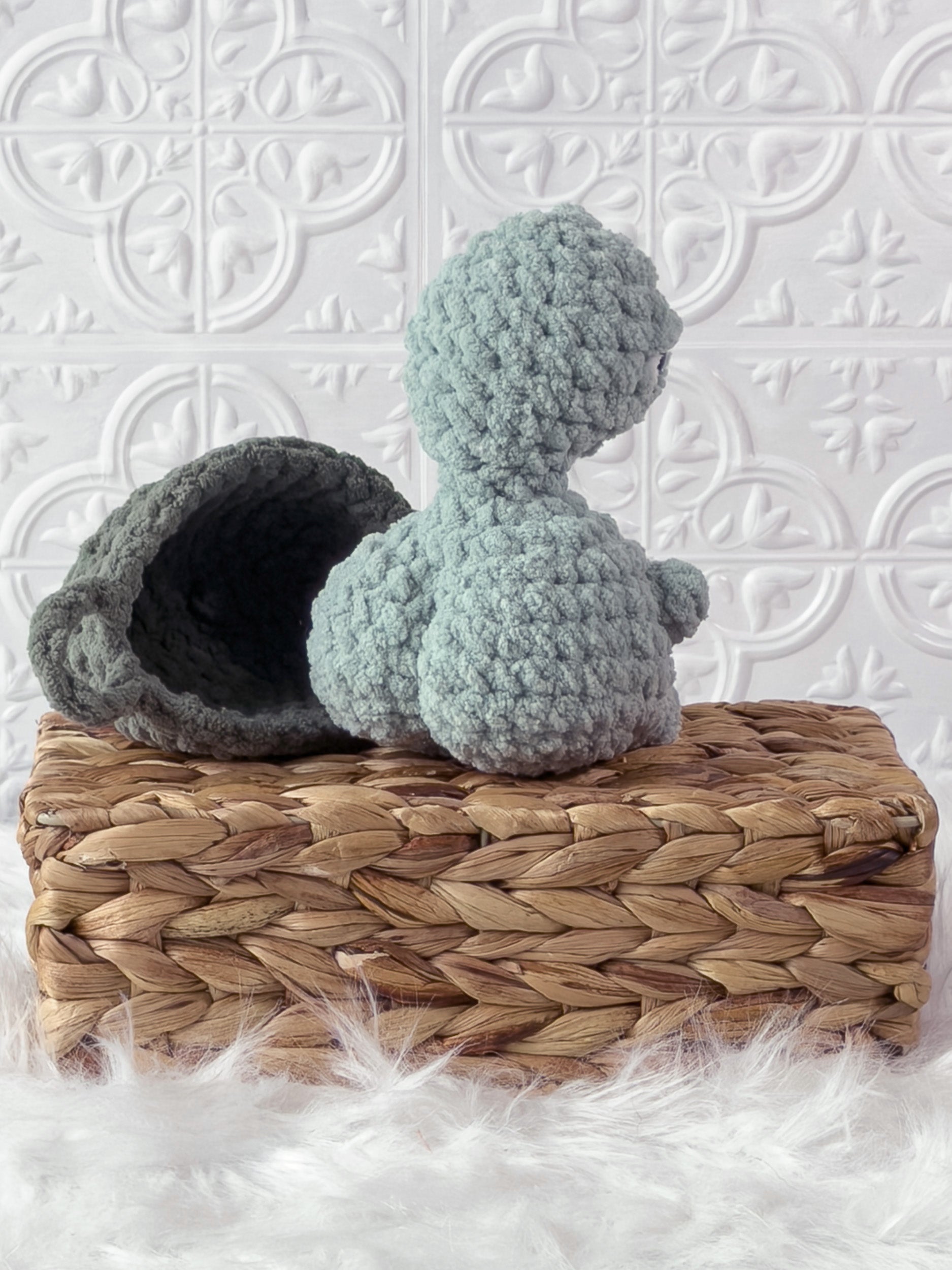Handmade turquoise, medium turtle crochet plushie shown from the back
