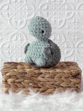 Handmade turtle crochet plushie shown from the front