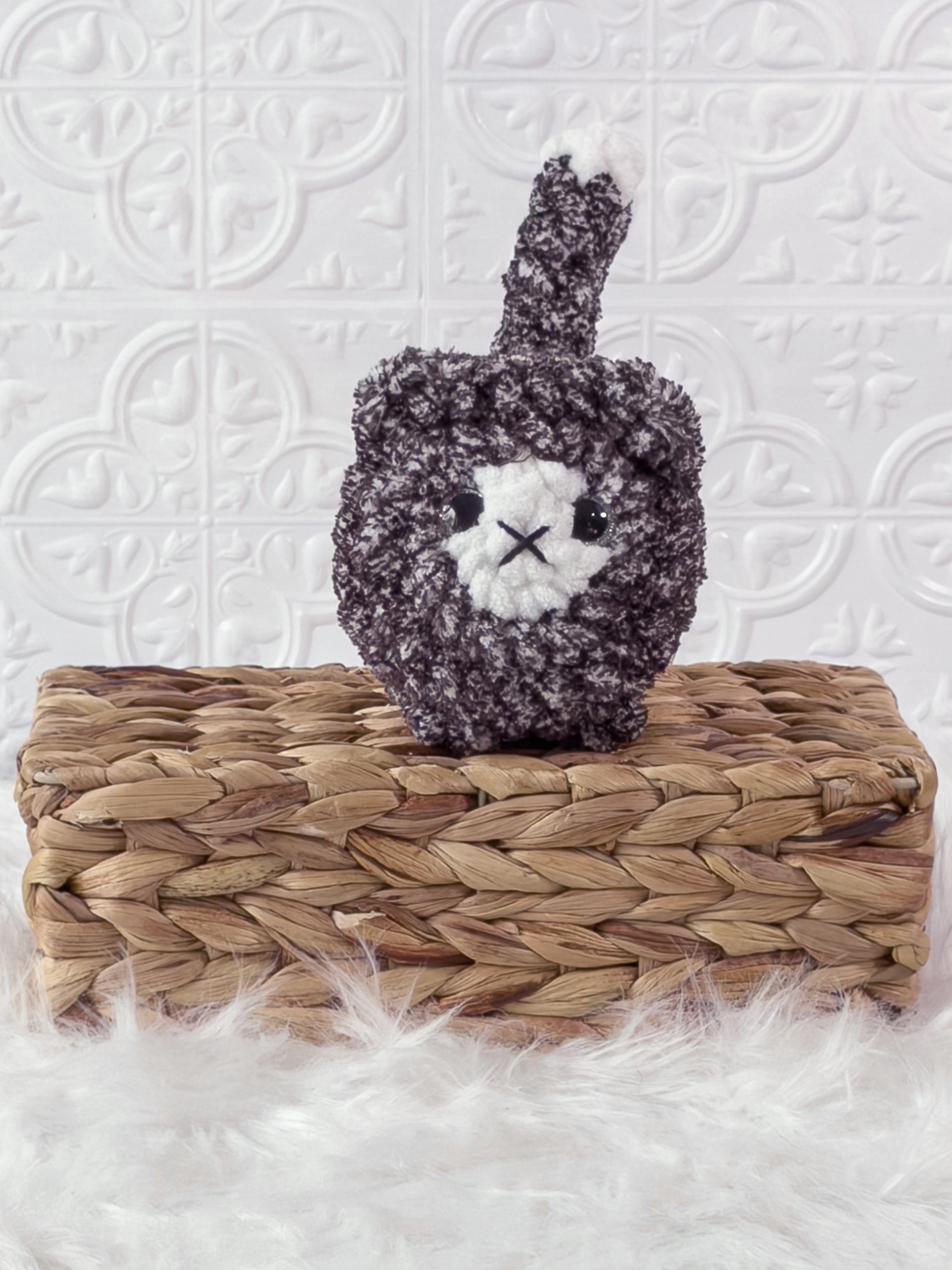 Handmade tweed, black loaf cat crochet plushie shown from the front