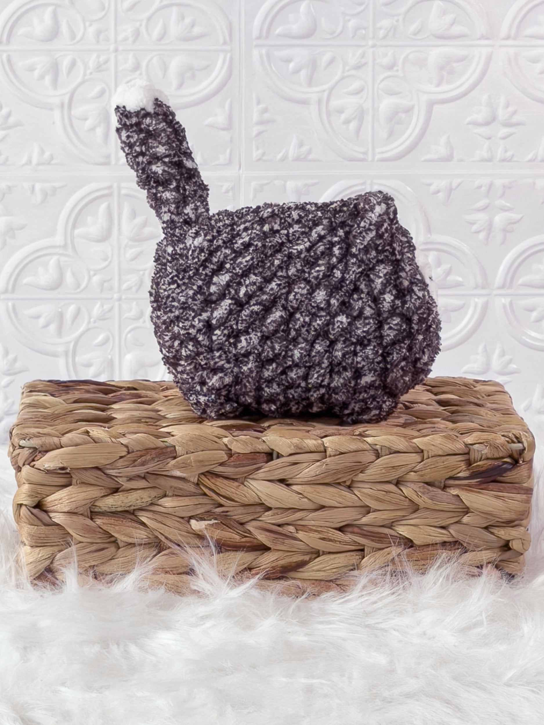 Handmade tweed, black loaf cat crochet plushie shown from the side