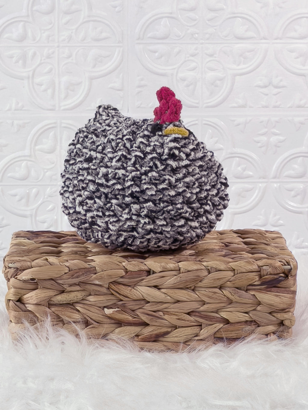 Handmade tweed, black chicken crochet plushie shown from an angled view