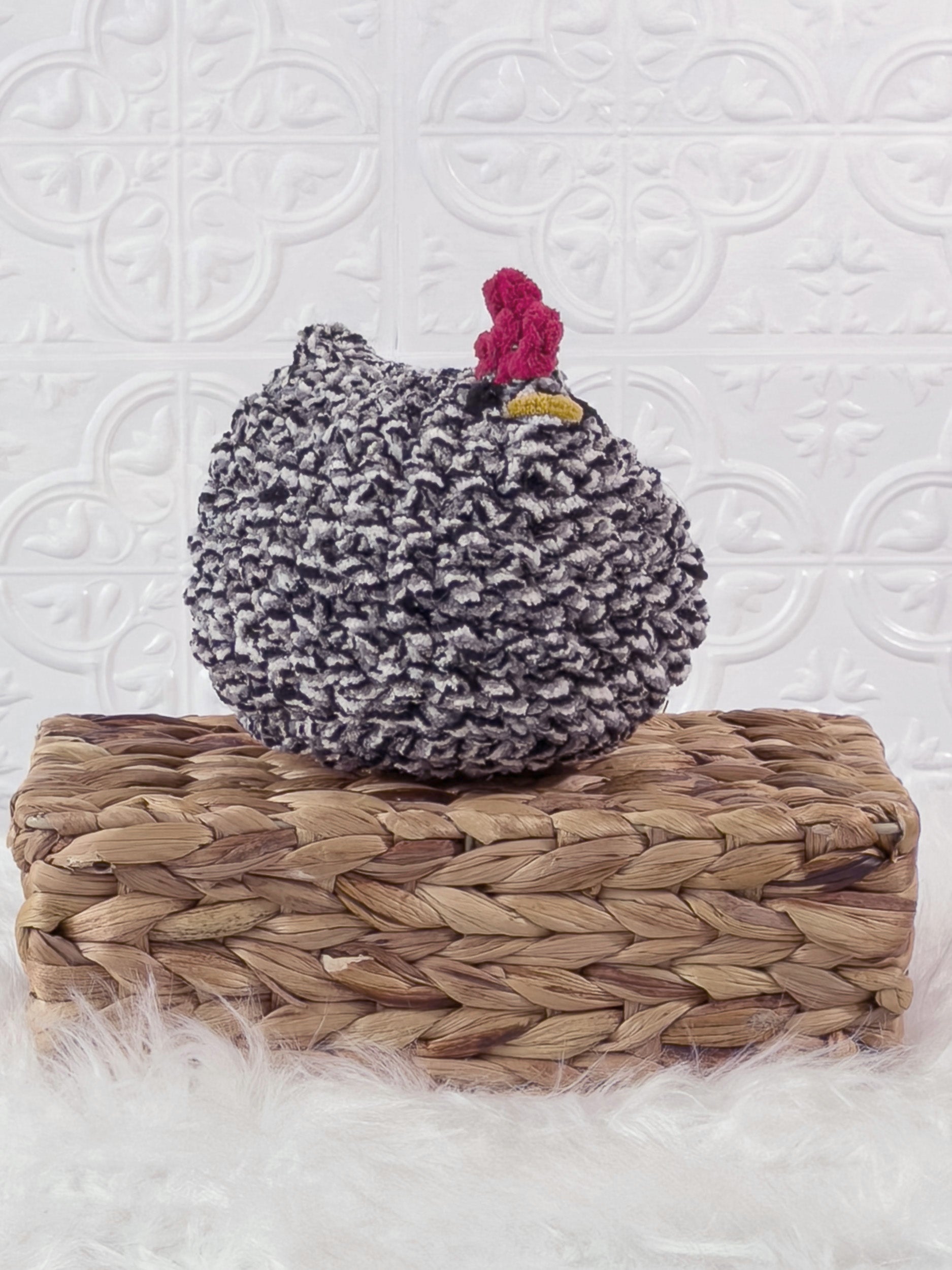 Handmade tweed, black chicken crochet plushie shown from an angled view