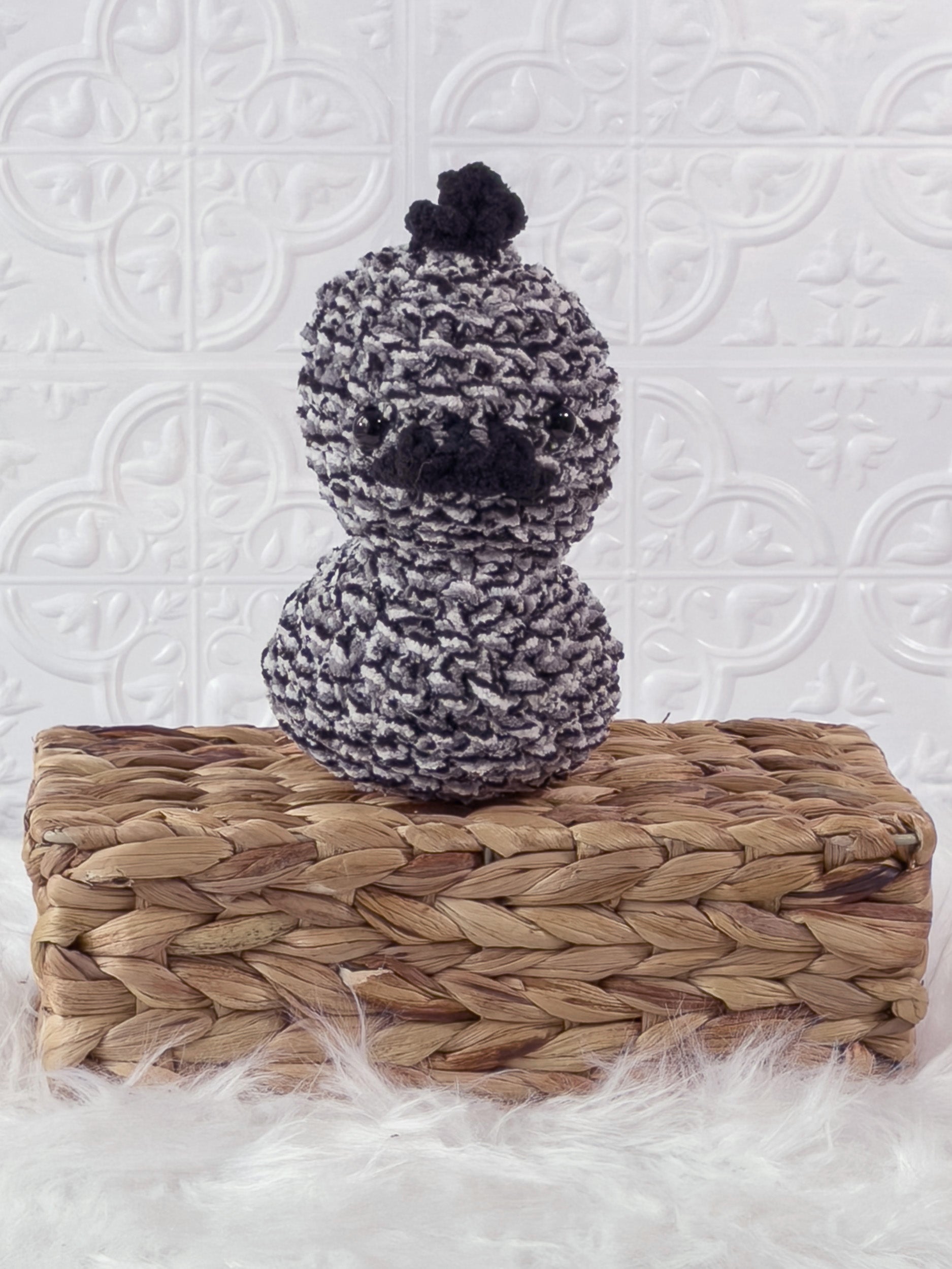 Handmade tweed, black rubber duck crochet plushie shown from the front
