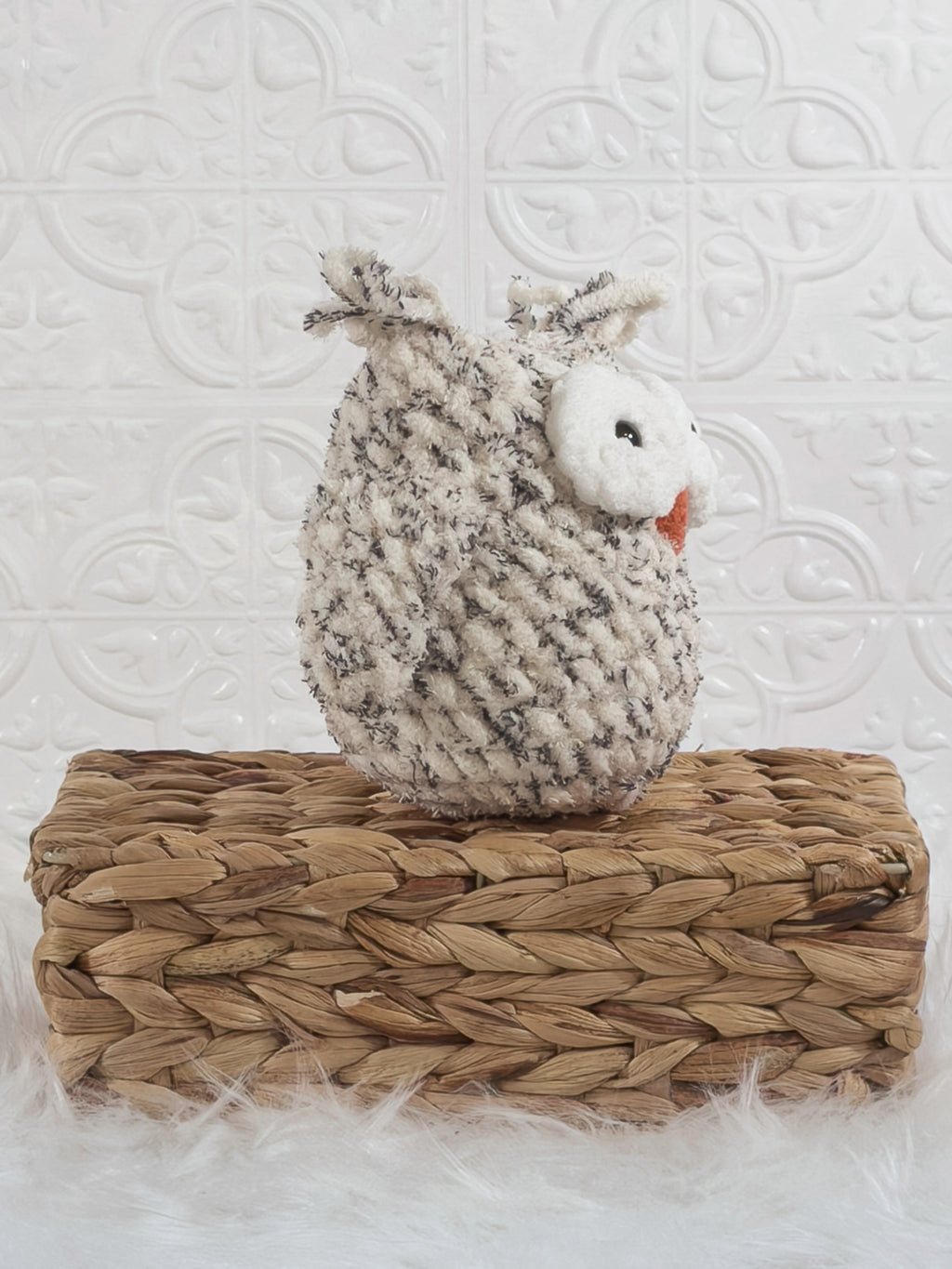 Handmade tweed owl crochet plushie shown from an angled view