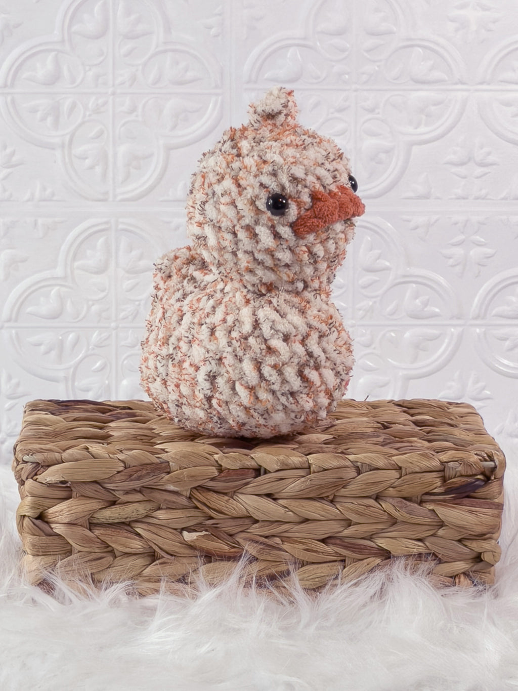 Handmade tweed, orange rubber duck crochet plushie shown from an angled view
