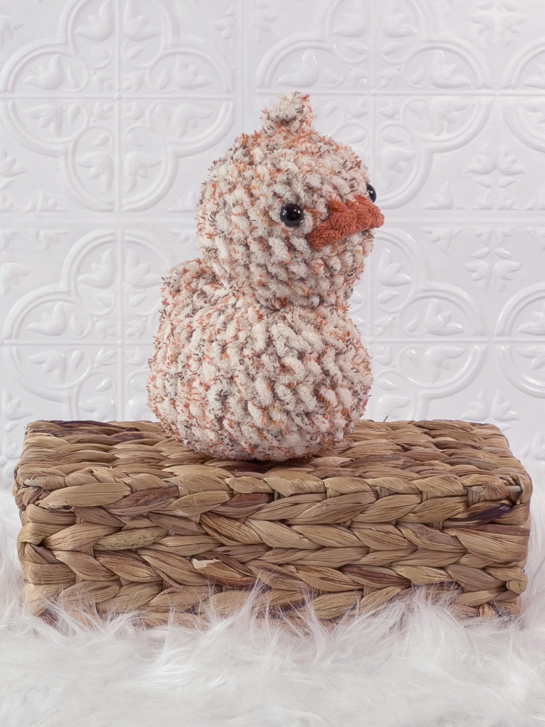 Handmade tweed, orange rubber duck crochet plushie shown from an angled view