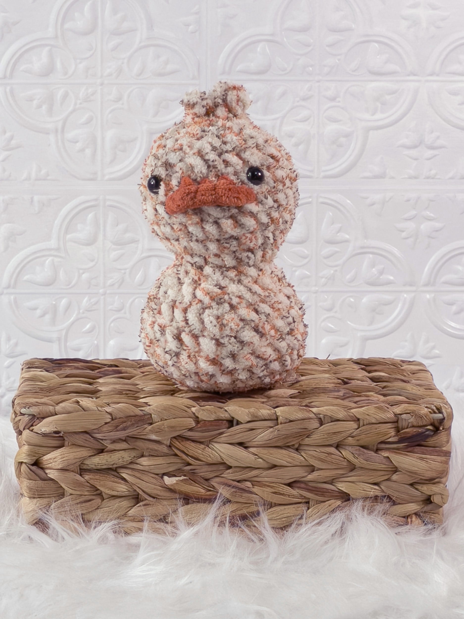 Handmade tweed, orange rubber duck crochet plushie shown from the front