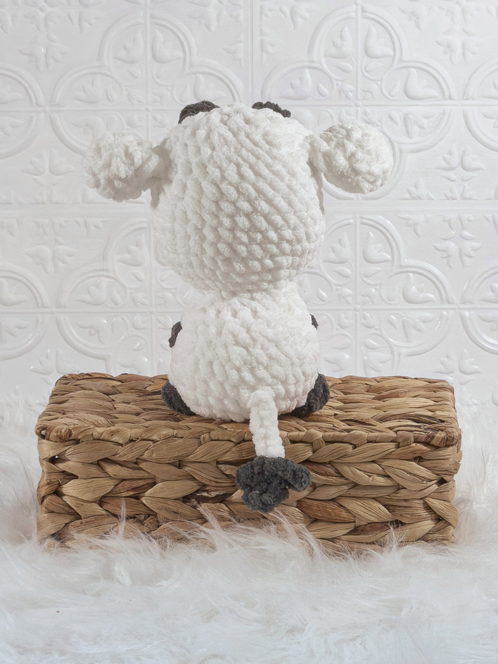 Handmade white cow crochet plushie shown from the back
