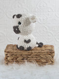 Handmade cow crochet plushie shown from the front