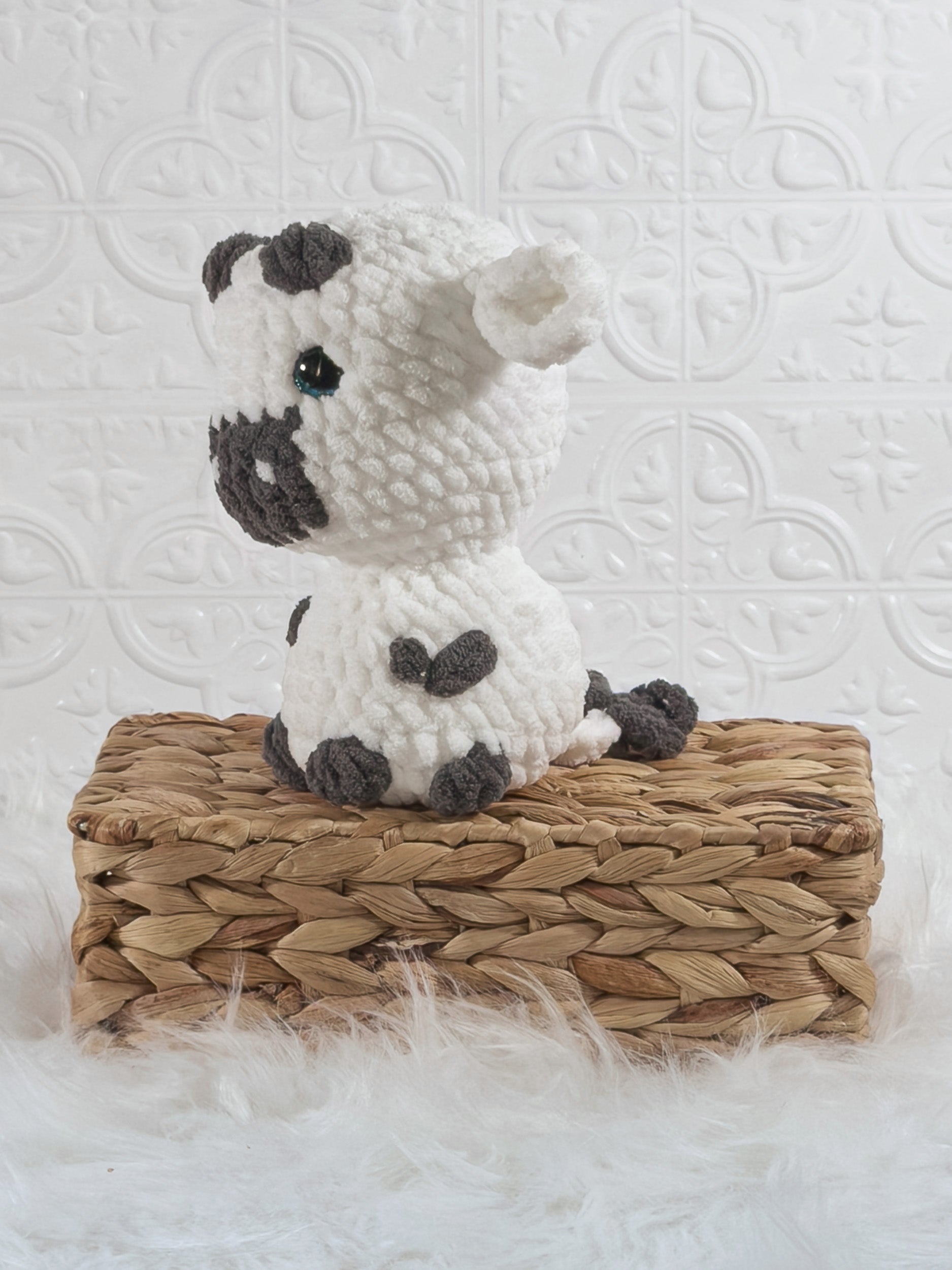 Handmade cow crochet plushie shown from the front