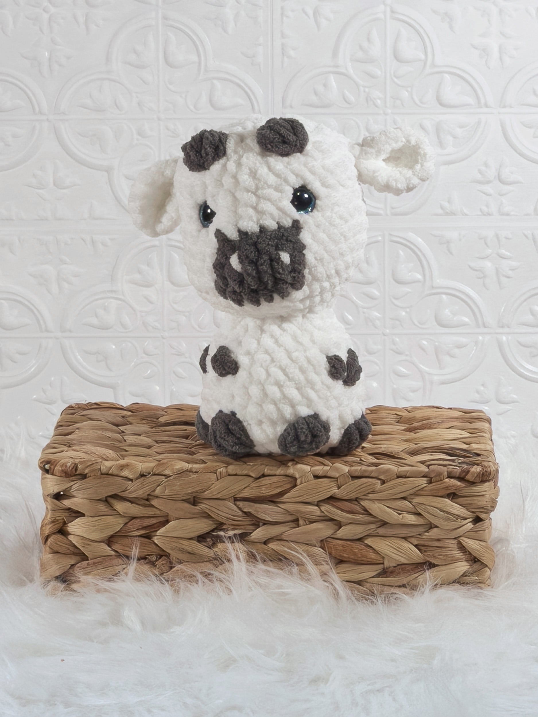 Handmade white cow crochet plushie shown from the front