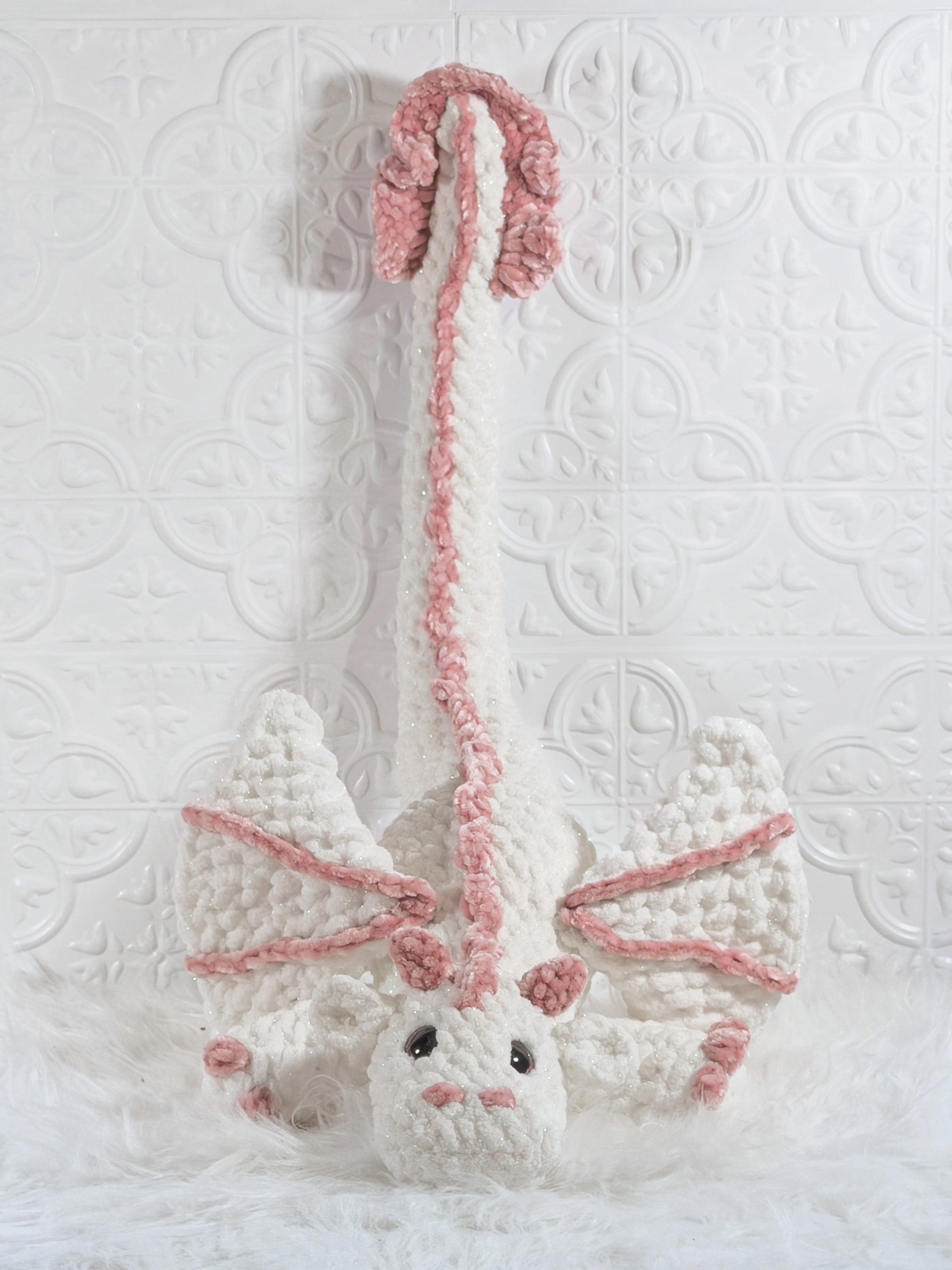 Handmade white dragon crochet plushie shown in a close-up detail view