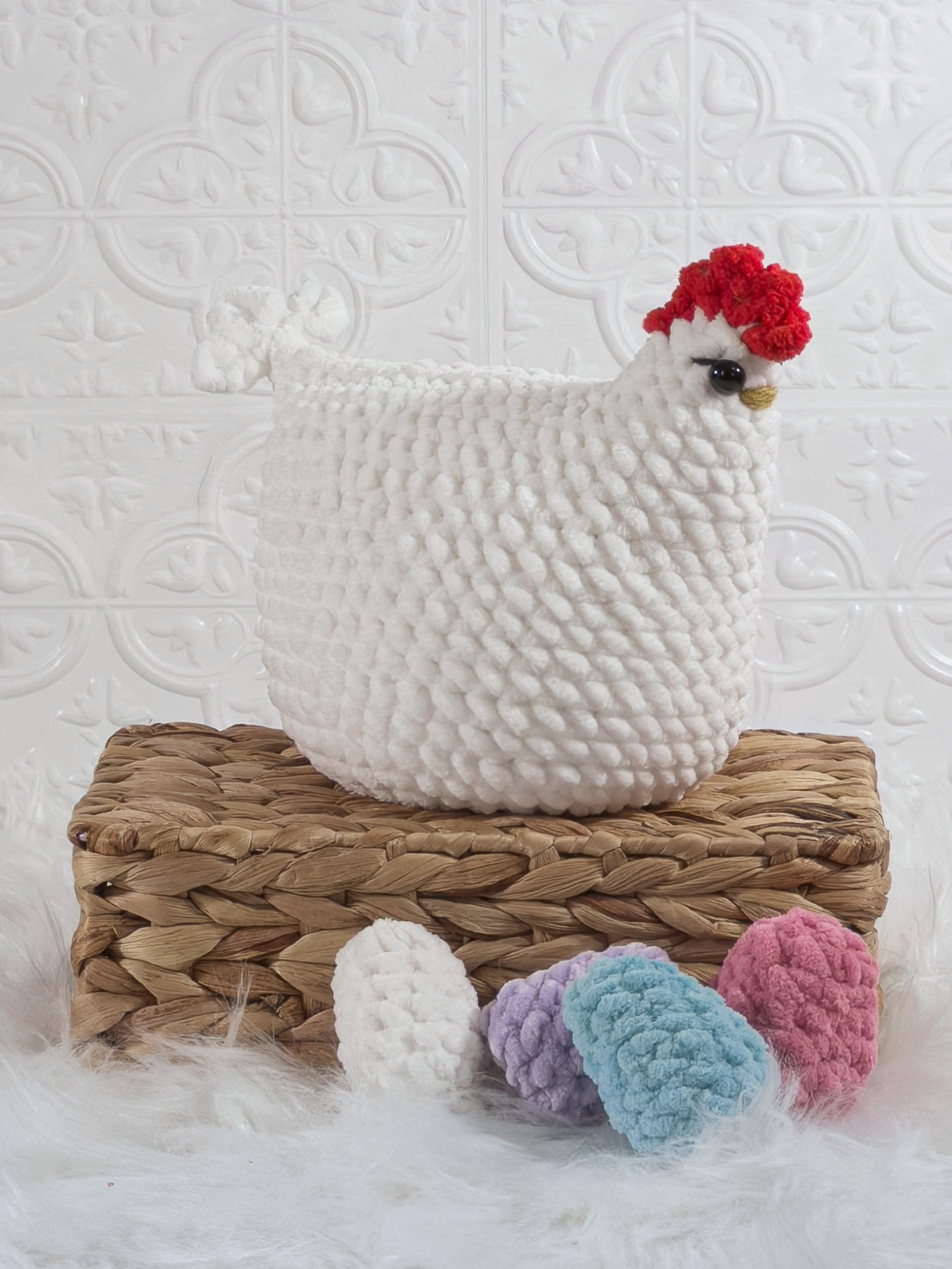 Handmade white hen with eggs crochet plushie shown from an angled view