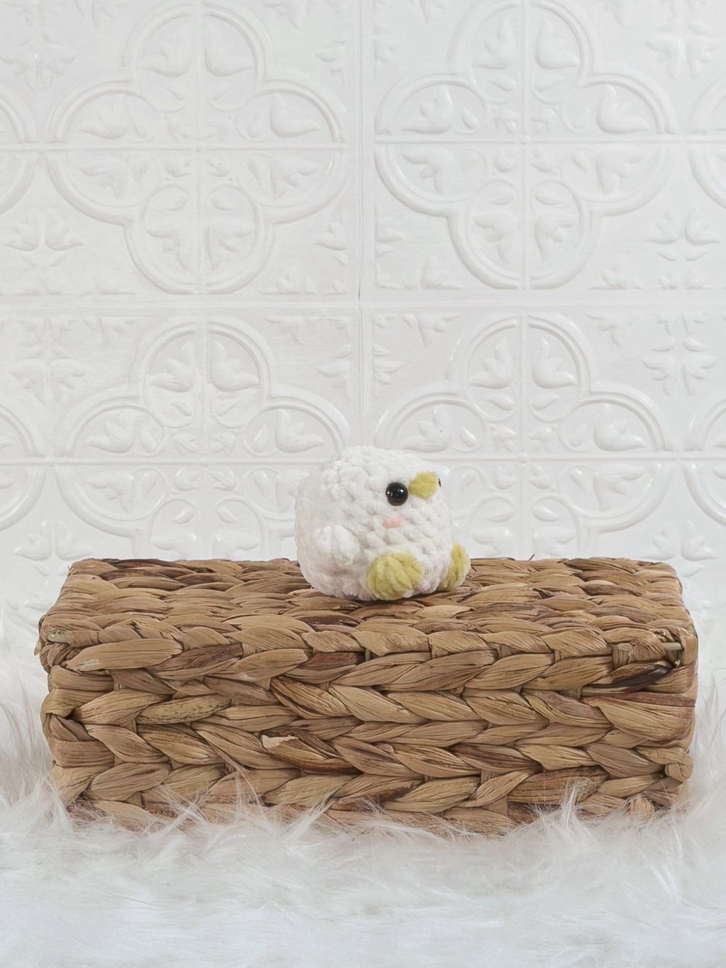 Handmade white, yellow baby chick crochet plushie shown from an angled view