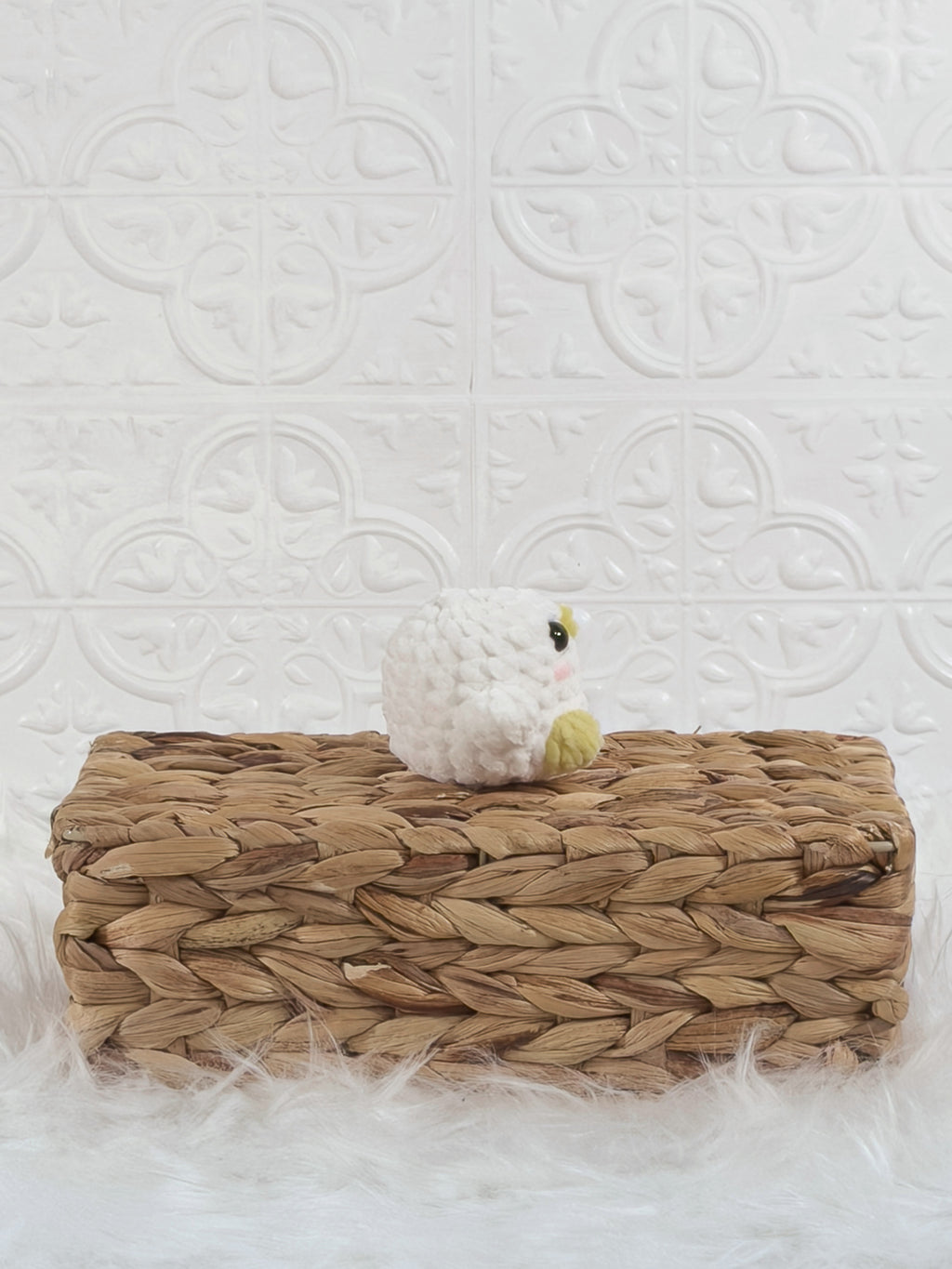 Handmade white, yellow baby chick crochet plushie shown from the side