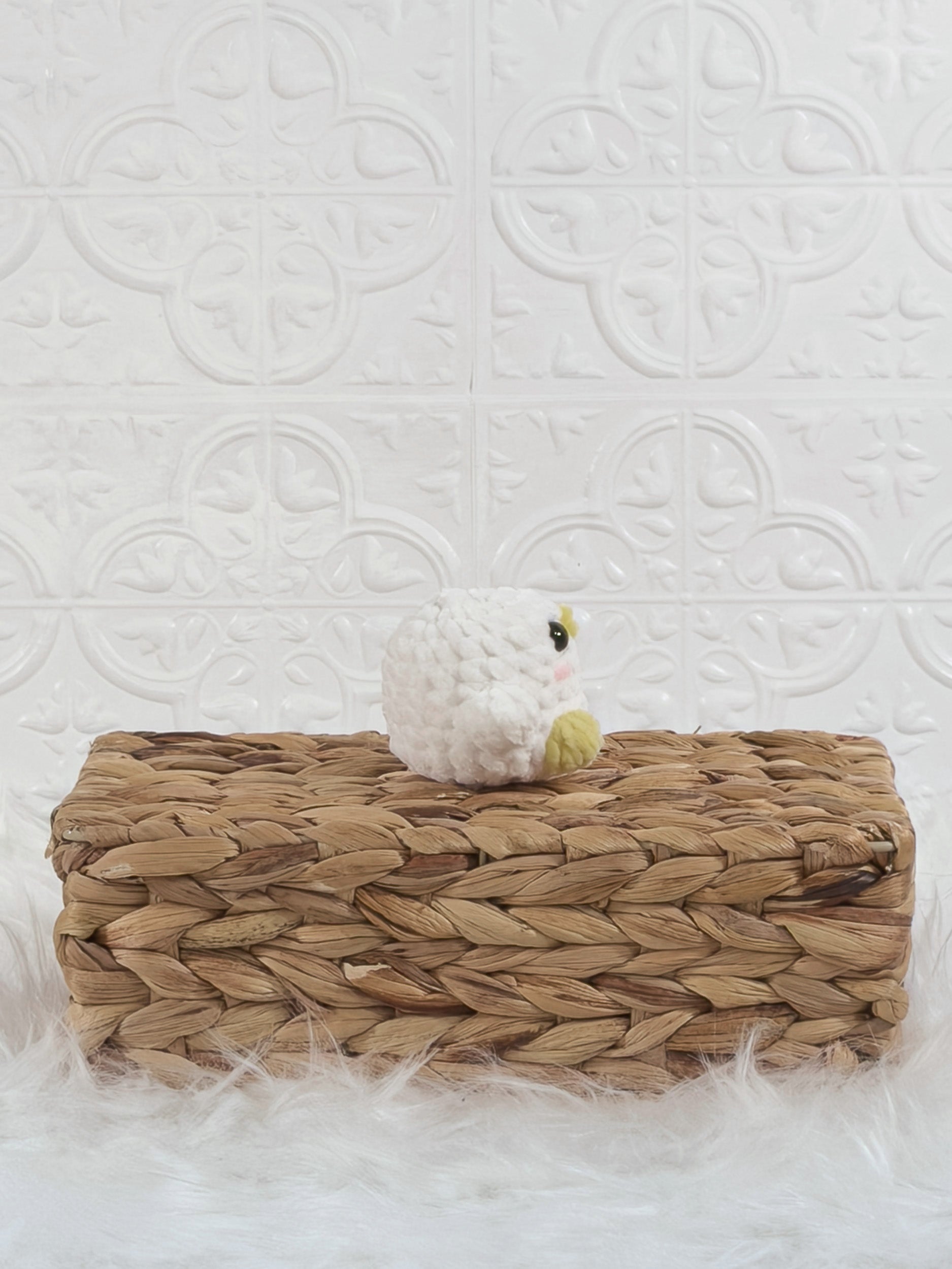 Handmade white, yellow baby chick crochet plushie shown from the side