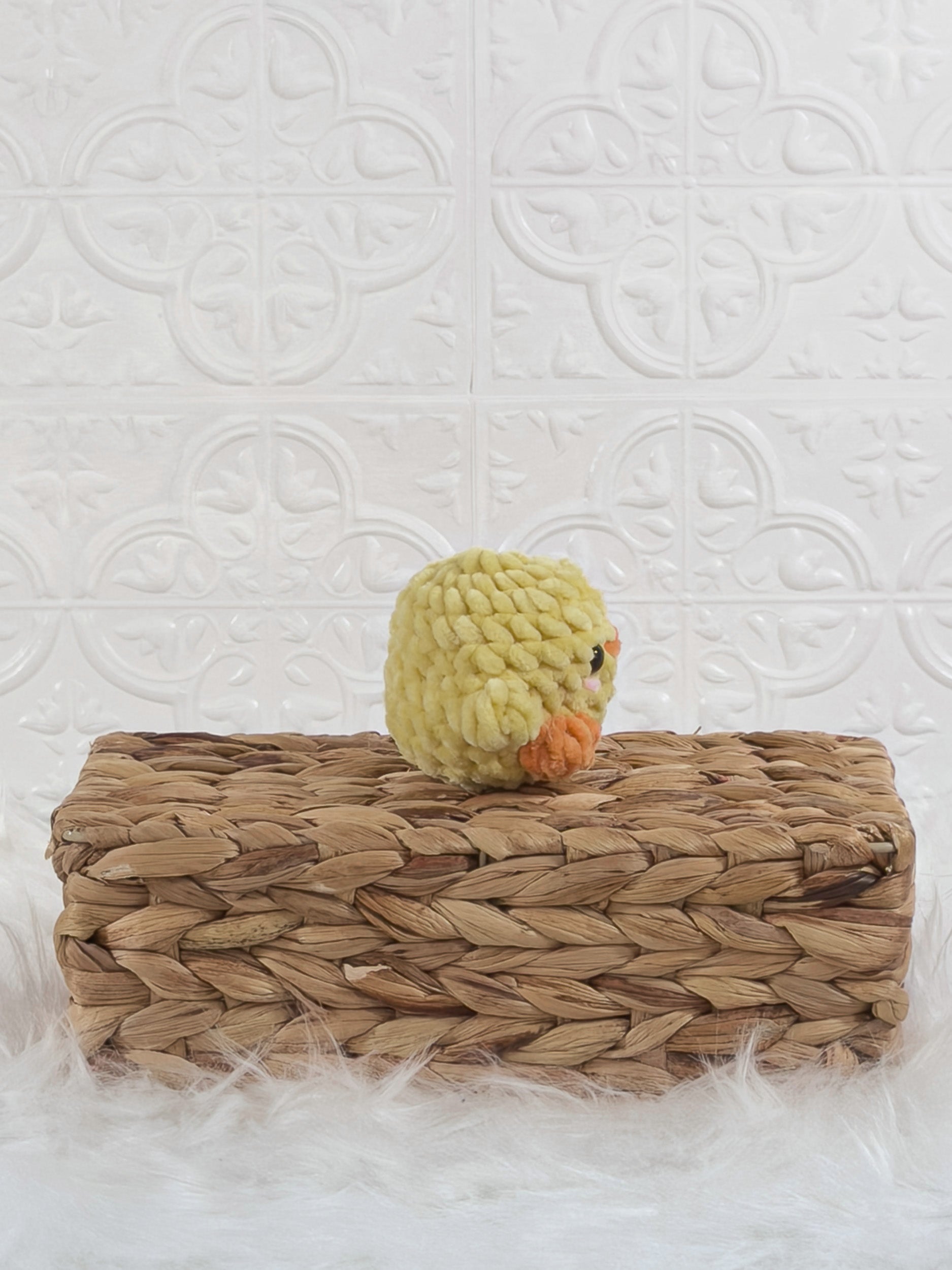 Handmade yellow baby chick crochet plushie shown from the side
