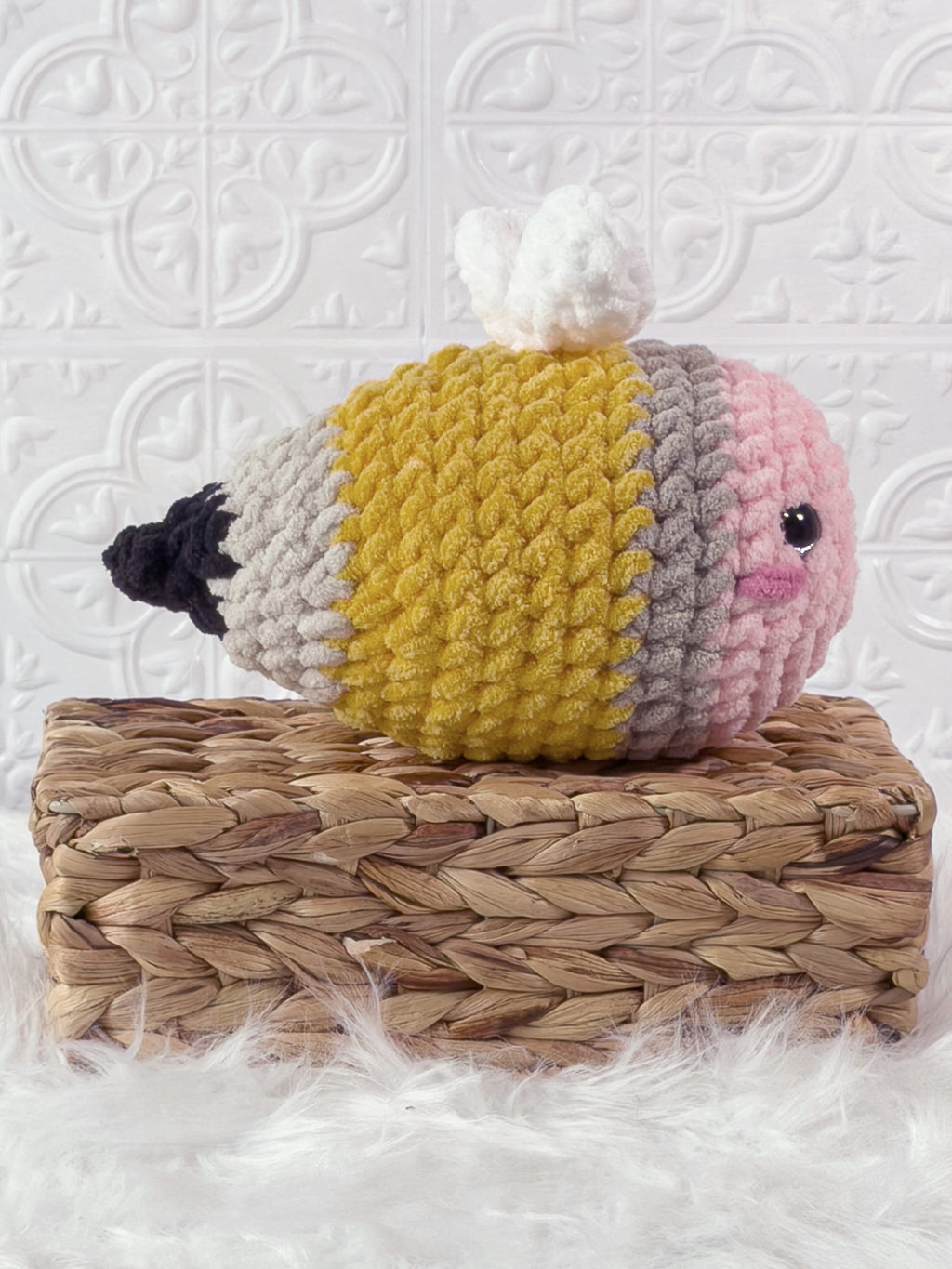 Handmade yellow bee pencil crochet plushie shown from the side