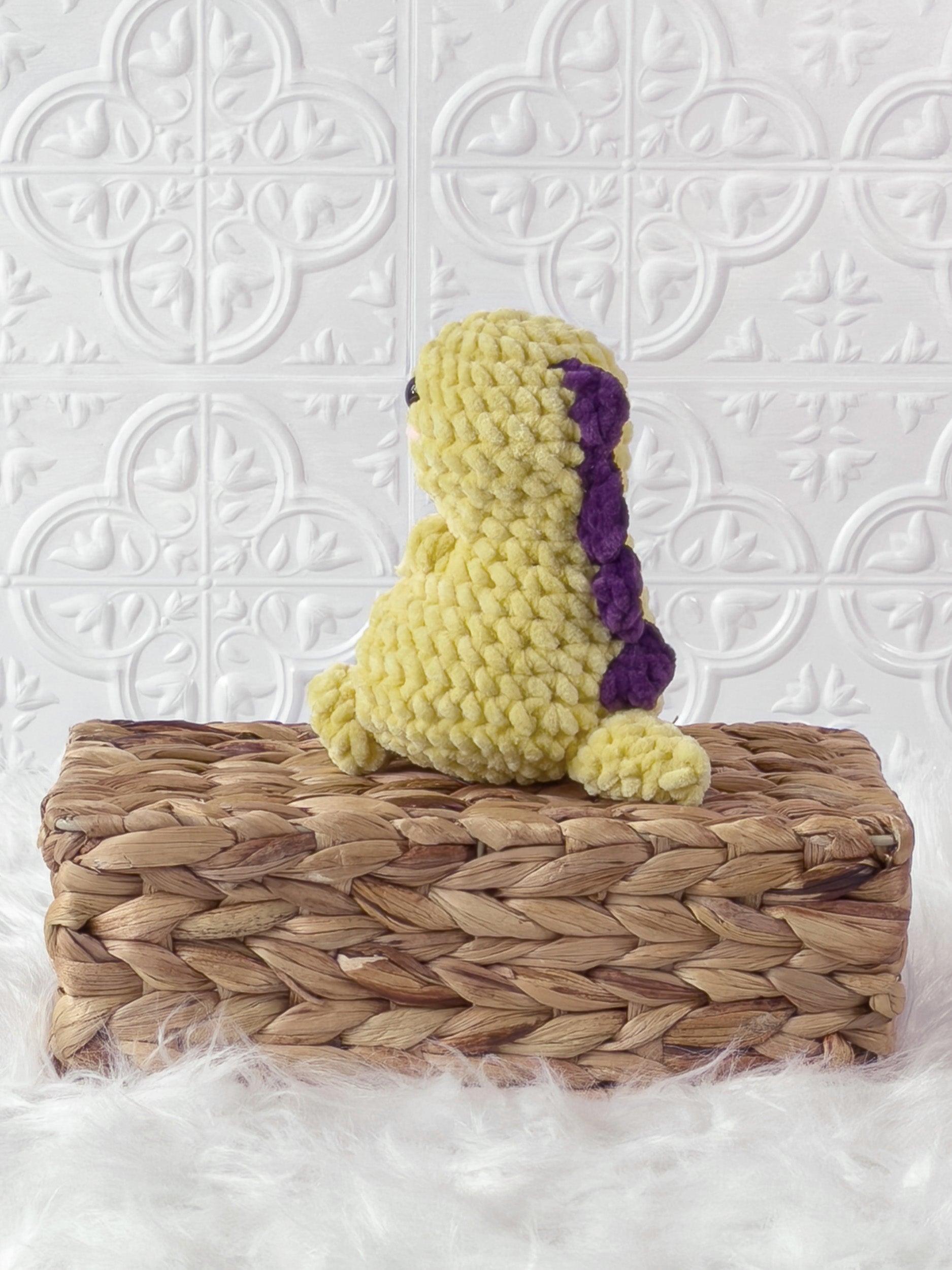 Handmade yellow chunky dino crochet plushie shown from the back