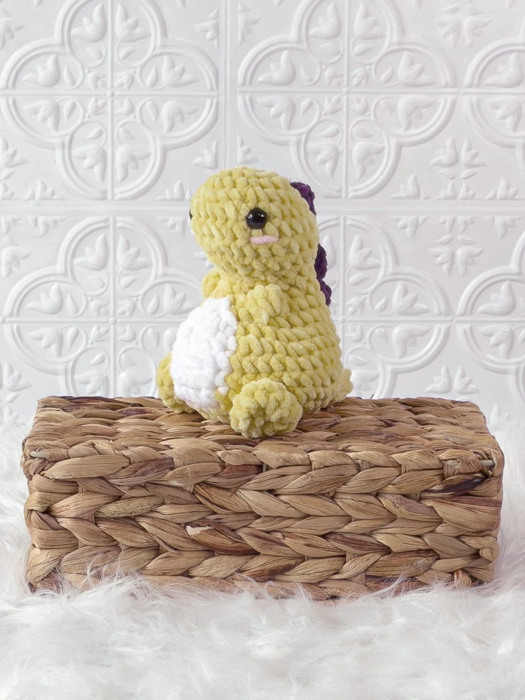 Handmade chunky dinosaur crochet plushie with a rounded prehistoric design