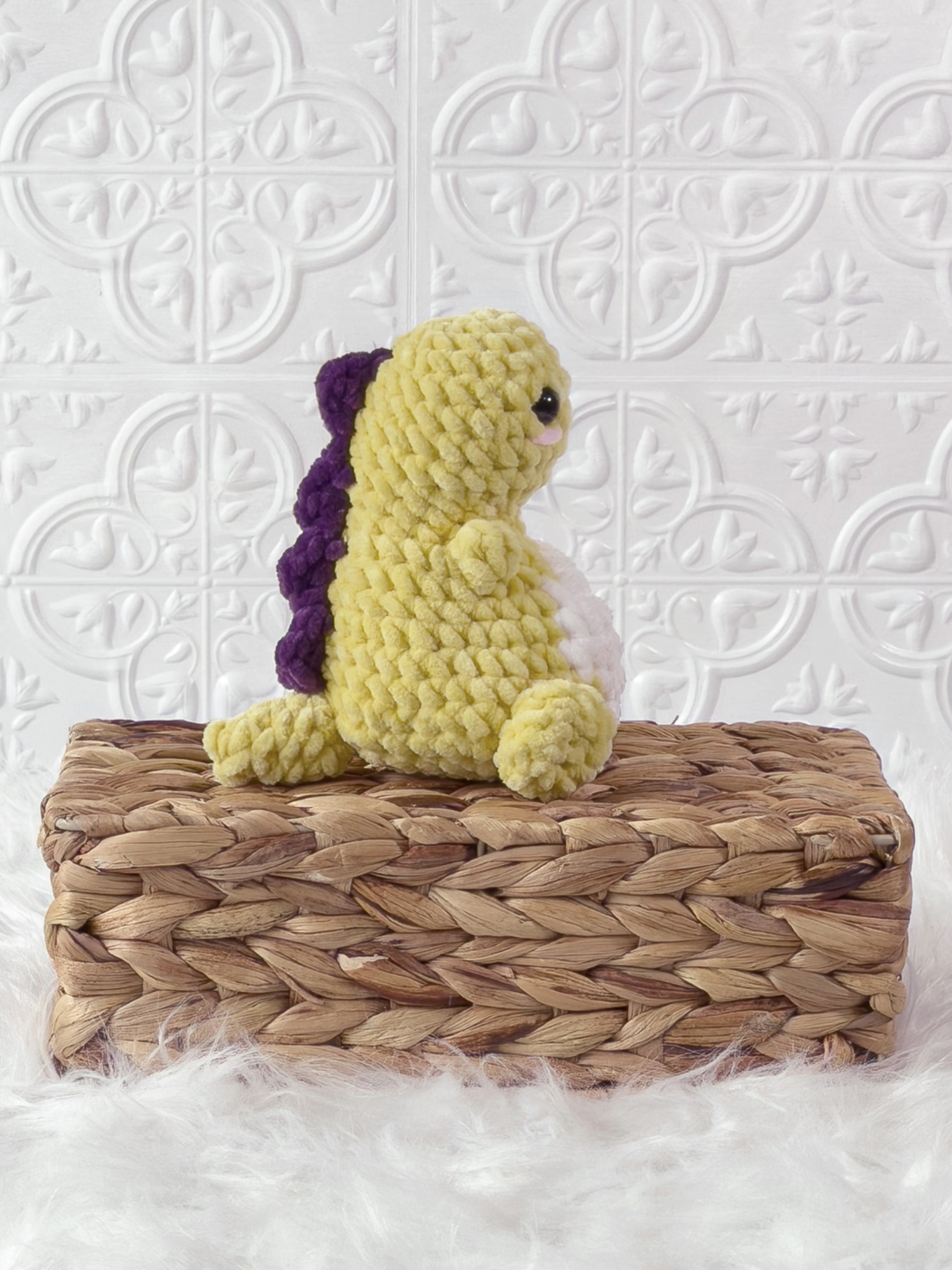 Handmade yellow chunky dino crochet plushie shown from the side