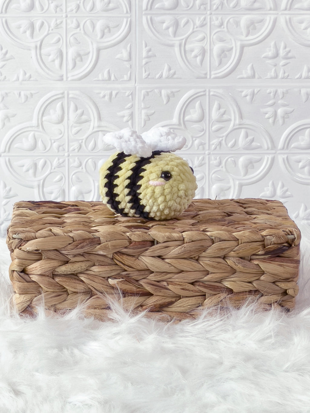 Handmade yellow mini bee crochet plushie shown from an angled view