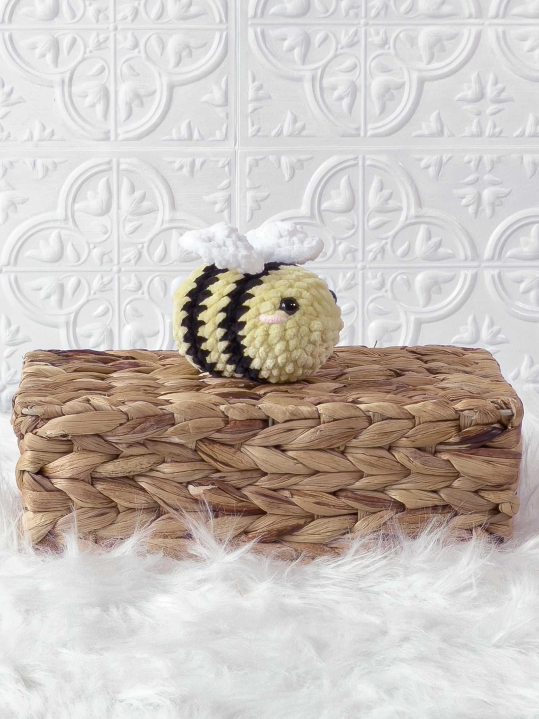 Handmade yellow mini bee crochet plushie shown from an angled view