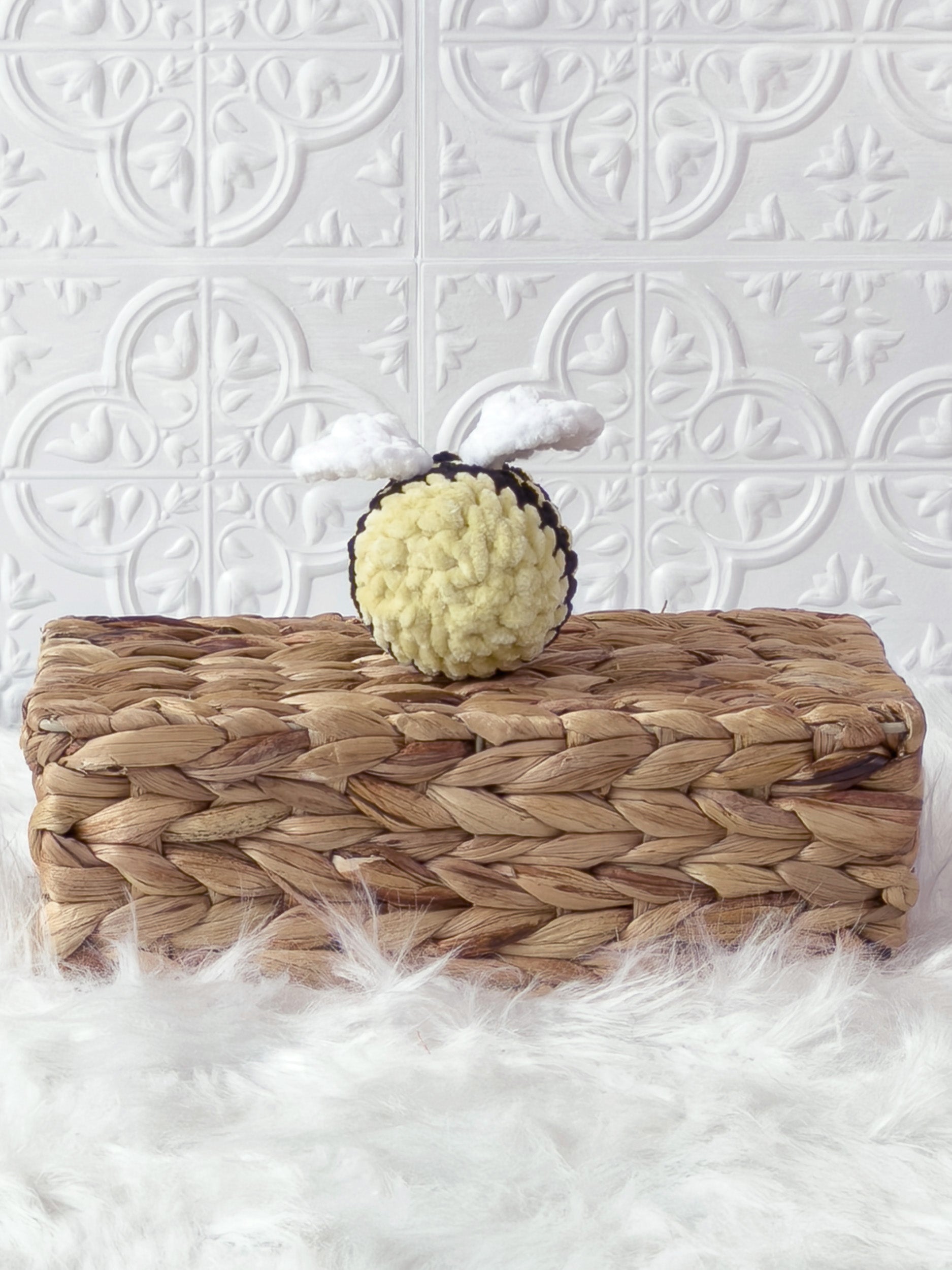 Handmade yellow mini bee crochet plushie shown from the back