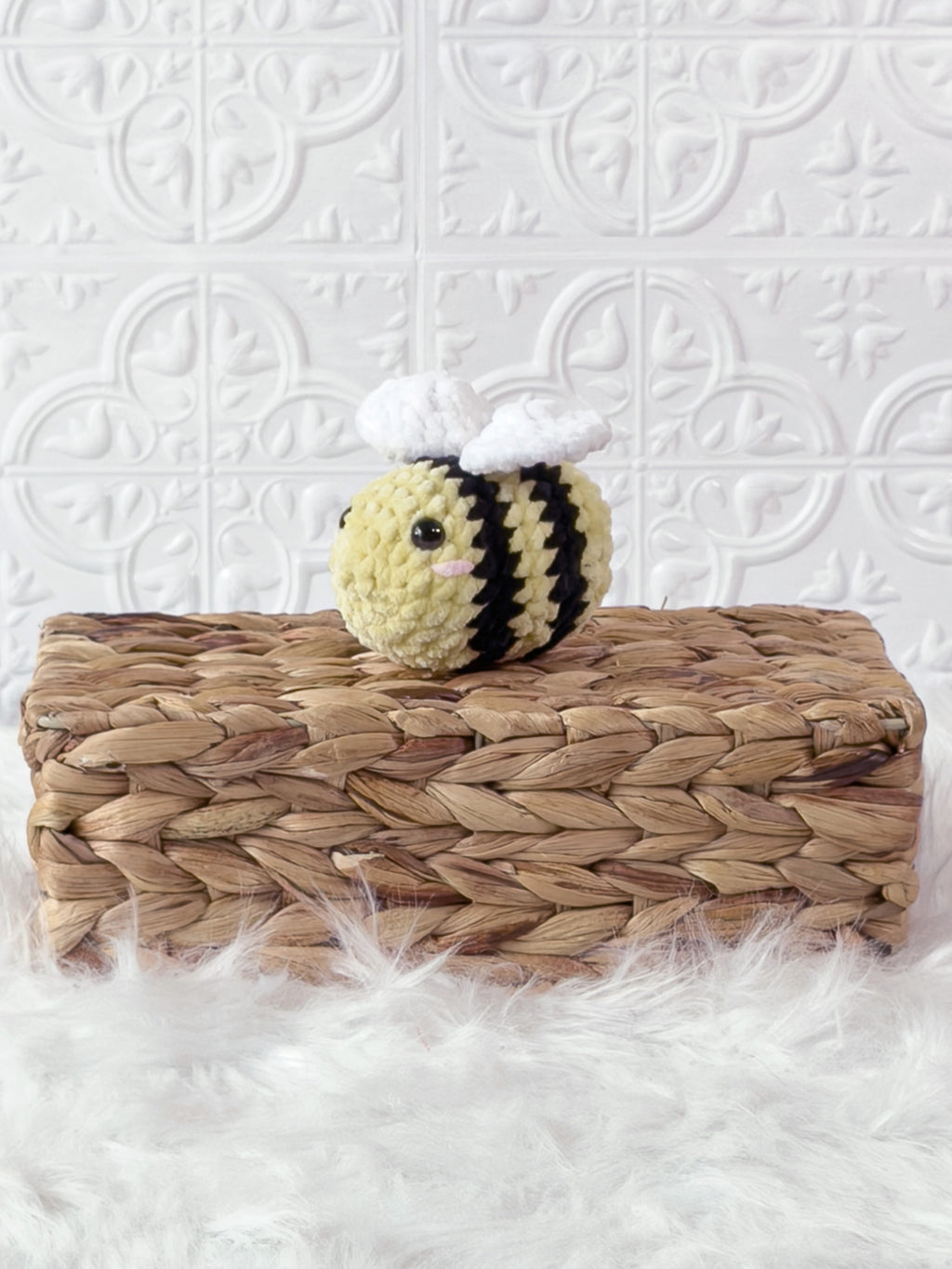 Small handmade bee crochet plushie shown from the front