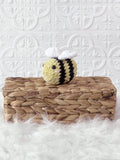 Small handmade bee crochet plushie shown from the front