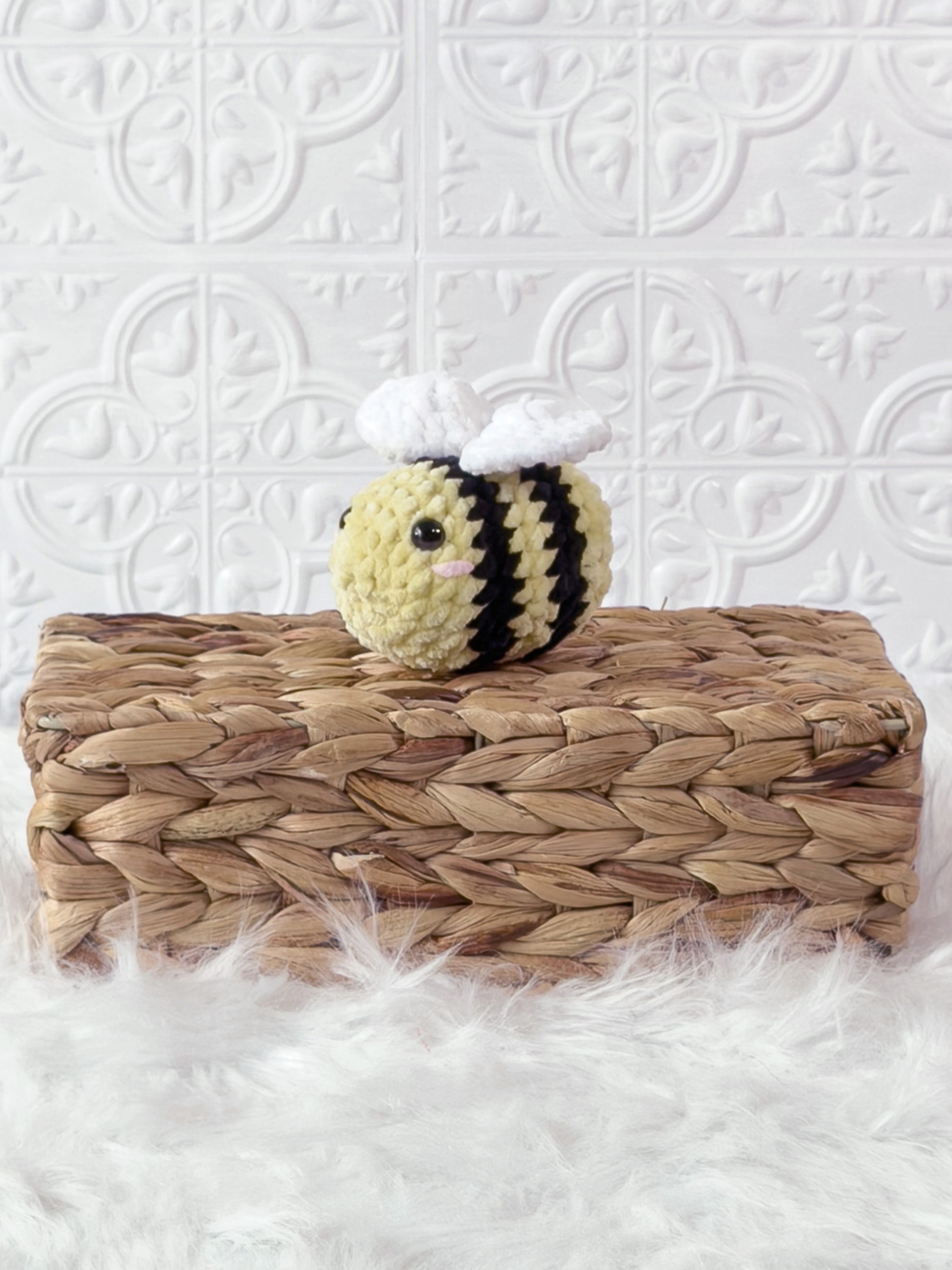 Small handmade bee crochet plushie shown from the front