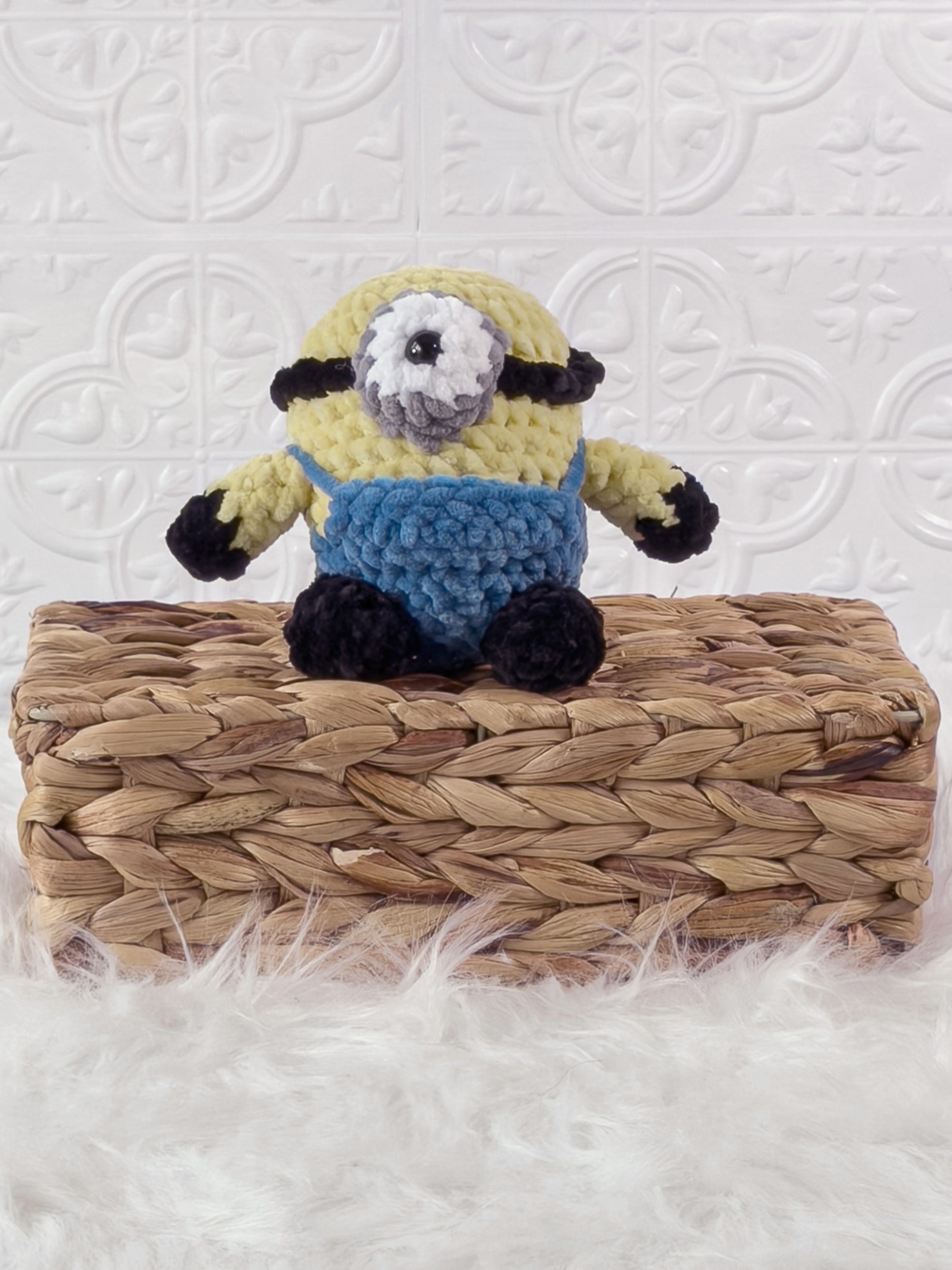 Handmade yellow minion crochet plushie shown from the front