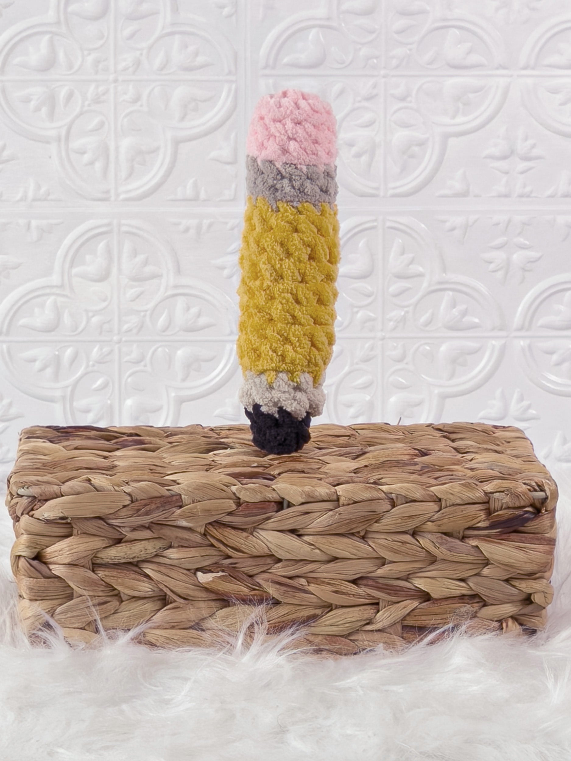 Handmade yellow pencil crochet plushie shown from an angled view
