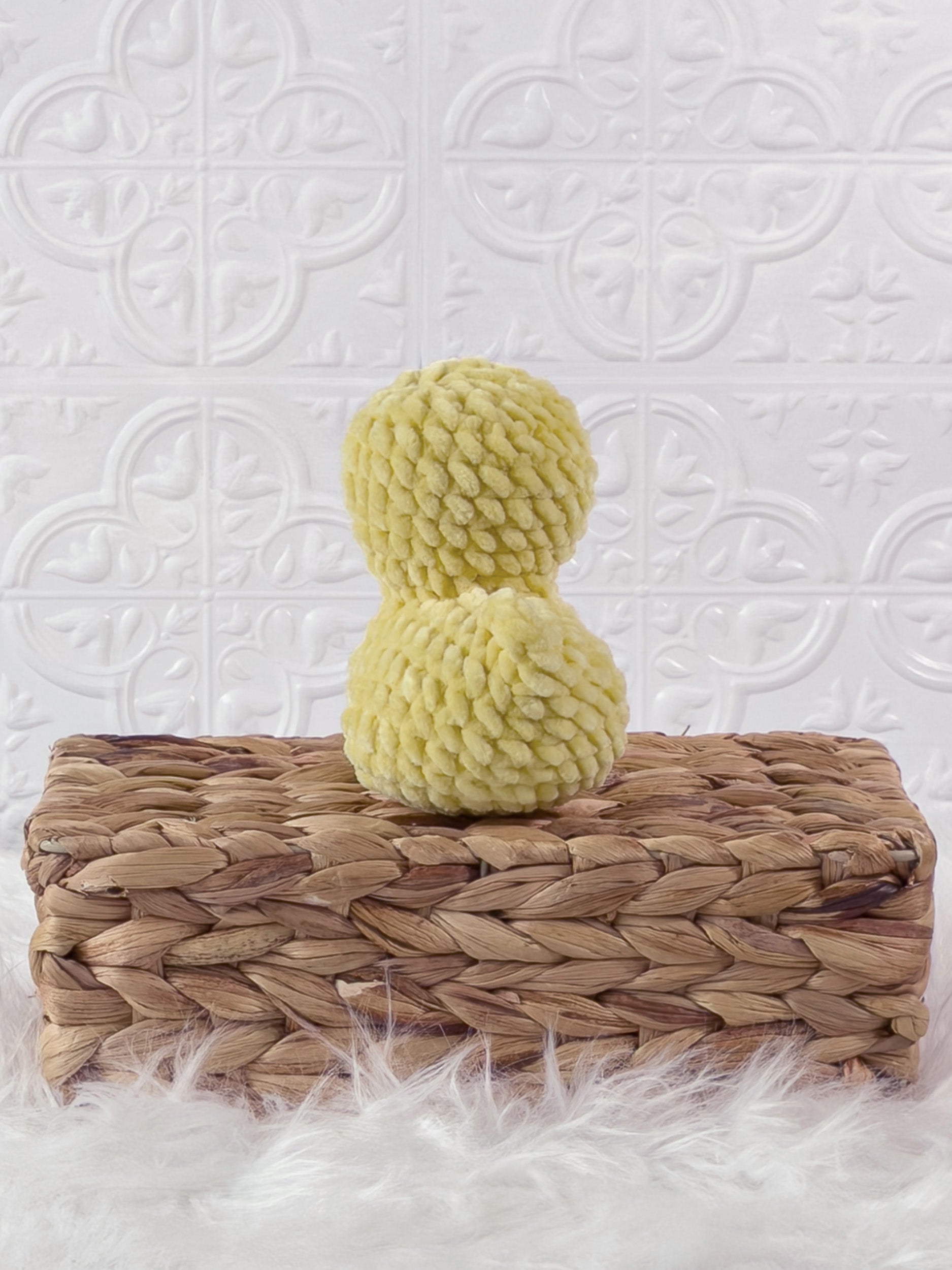 Handmade yellow rubber duck crochet plushie shown from the back